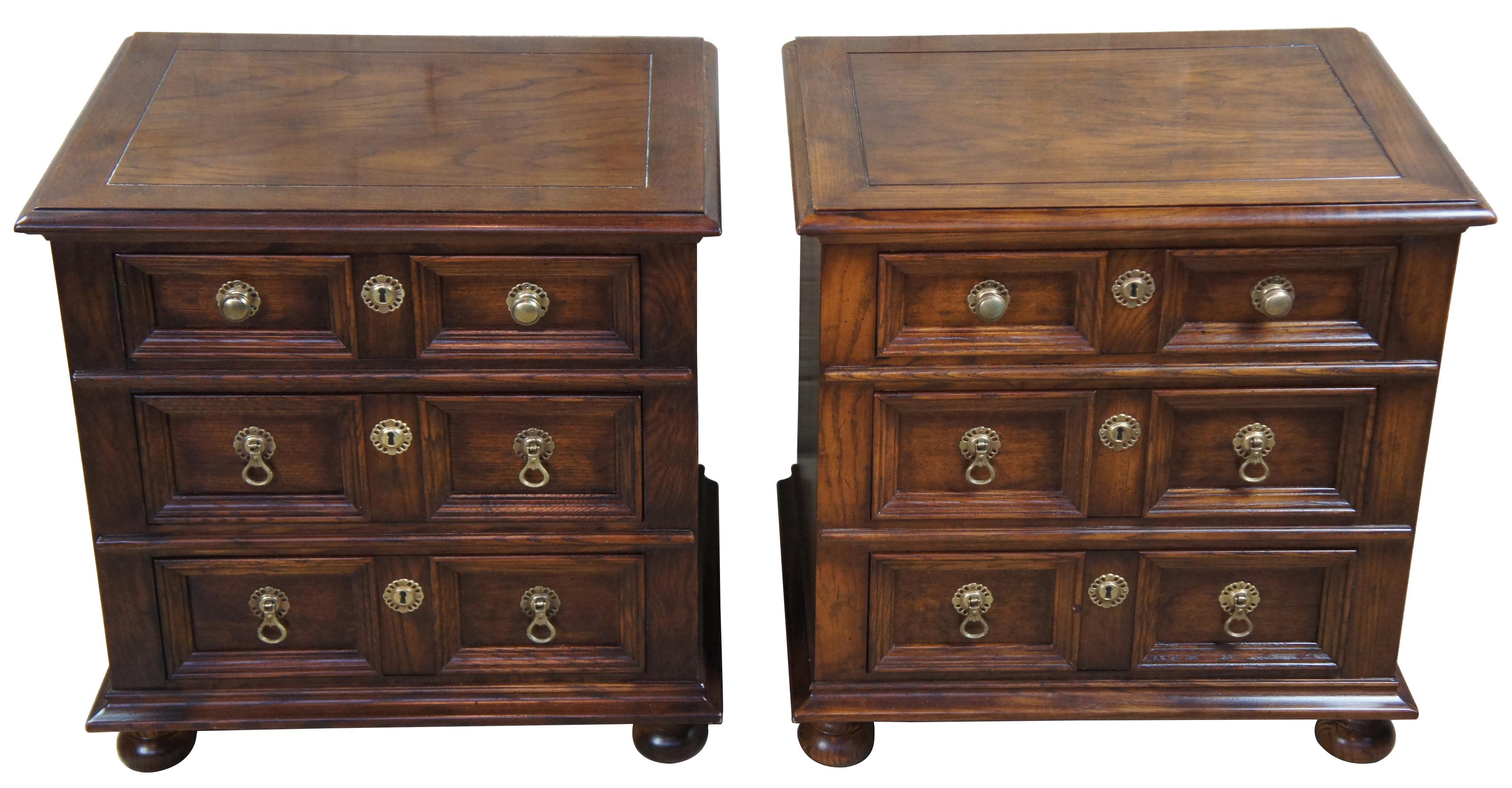 1979 Henredon folio 12 nightstands. Made from oak with Classic 18th century English styling. Includes robust paneled drawer fronts with Victorian inspired knockers, brass key plates and bun feet.