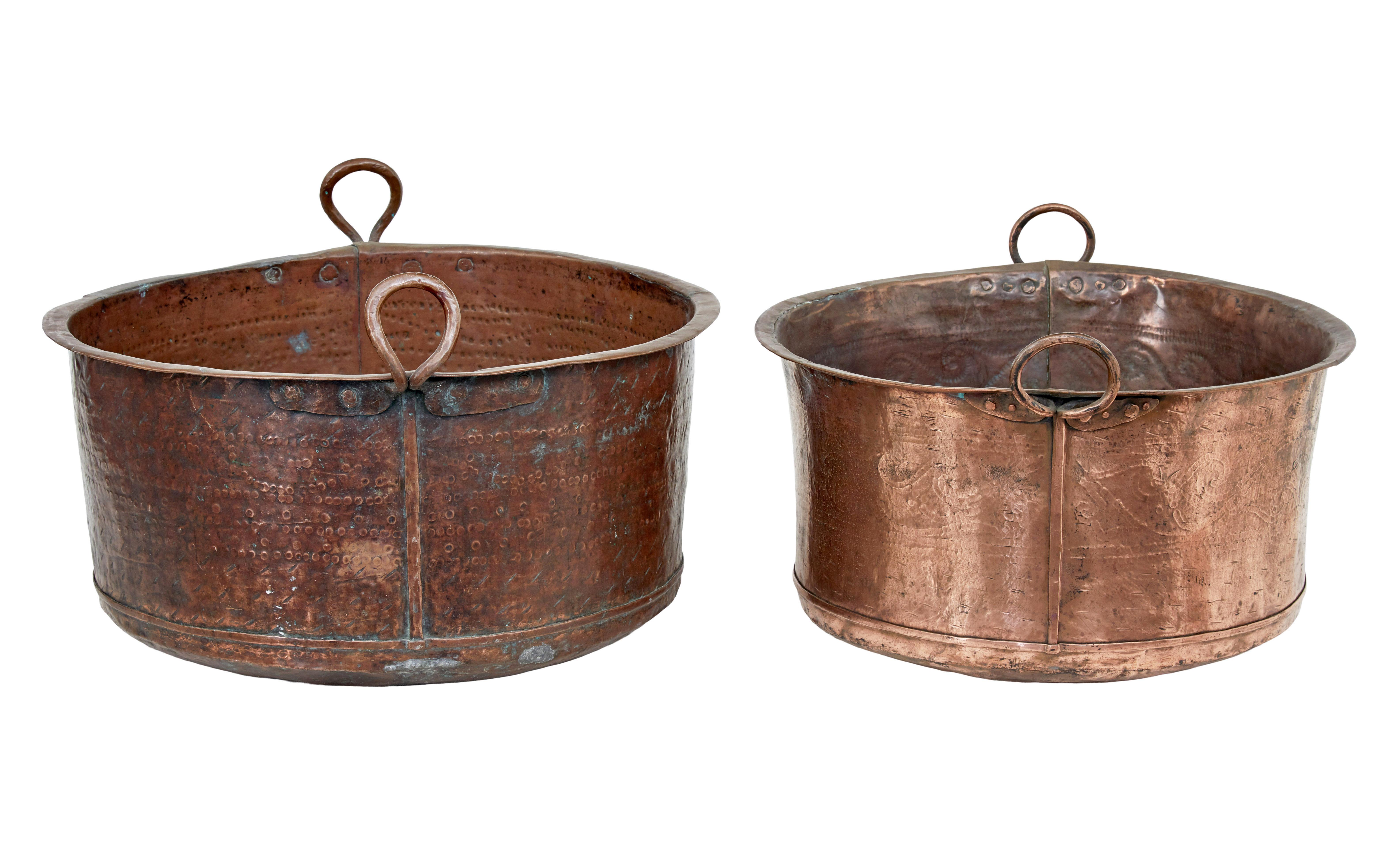 2 victorian large copper cooking vessels circa 1880.

Good quality each decorated with hand hammered designs, both fitted with looped handles.  Ideal for use and log/coal bins, or for decorative purposes.

Expected marks,staining and minor dings to
