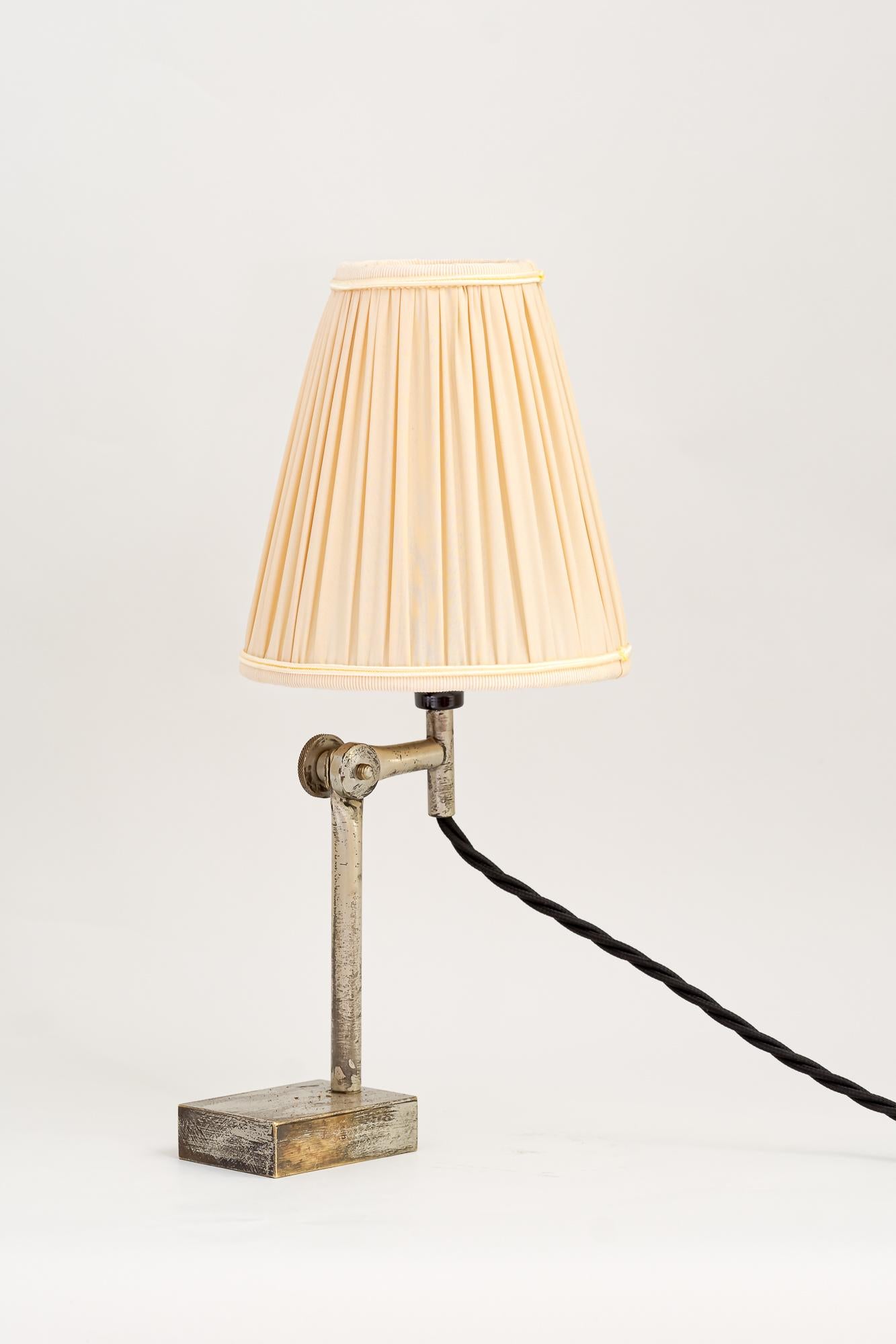 2 Adjustable Vintage table lamps, Vienna, around 1950s.
Brass silvered
Original condition
Only the shades are replaced ( new )
One is a little bit higher: 
H: 32cm
W: 14cm
D: 19cm.