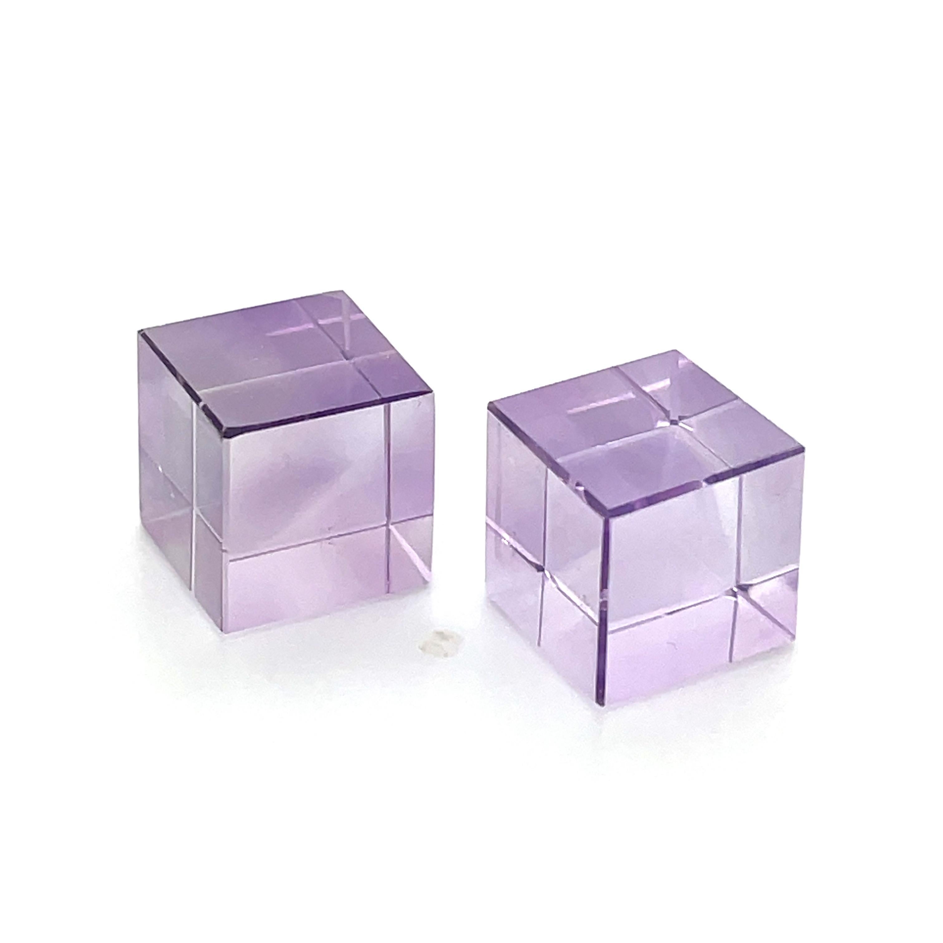 Illuminate your world with this pair. 

Each of these two exquisite amethyst cube stones is 10.1 x 10.1 mm, perfect squares with a combined weight of 26.42 carats.

They have a unique diagonal surface.

These magnificent cubes refract into a