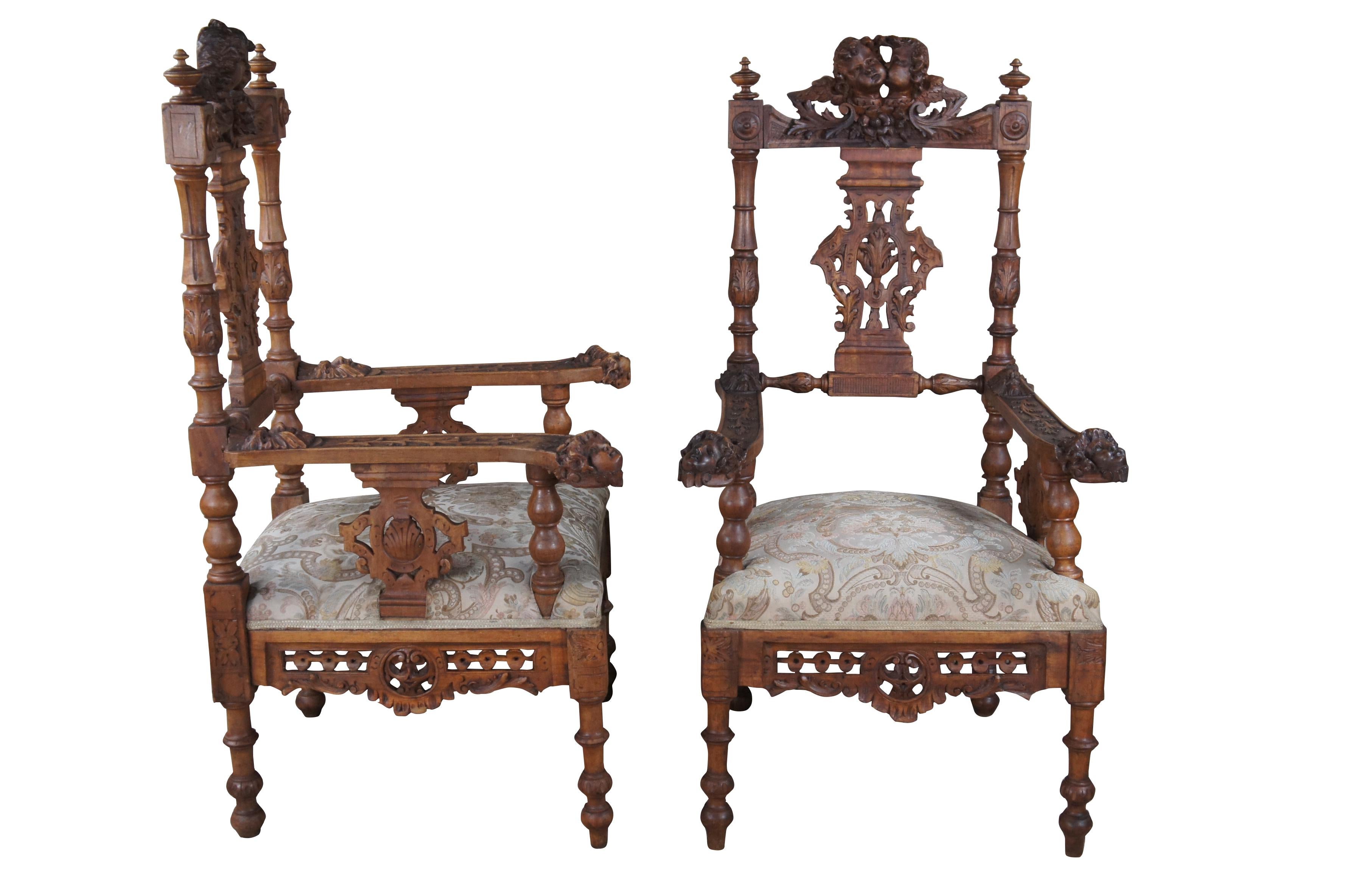 Two antique Italian Renaissance parlor armchairs, circa 1870s.  Made of walnut featuring ornate carved and reticulated design with figural puttis / angels / cherubs adorned throughout.

DIMENSIONS

24.5
