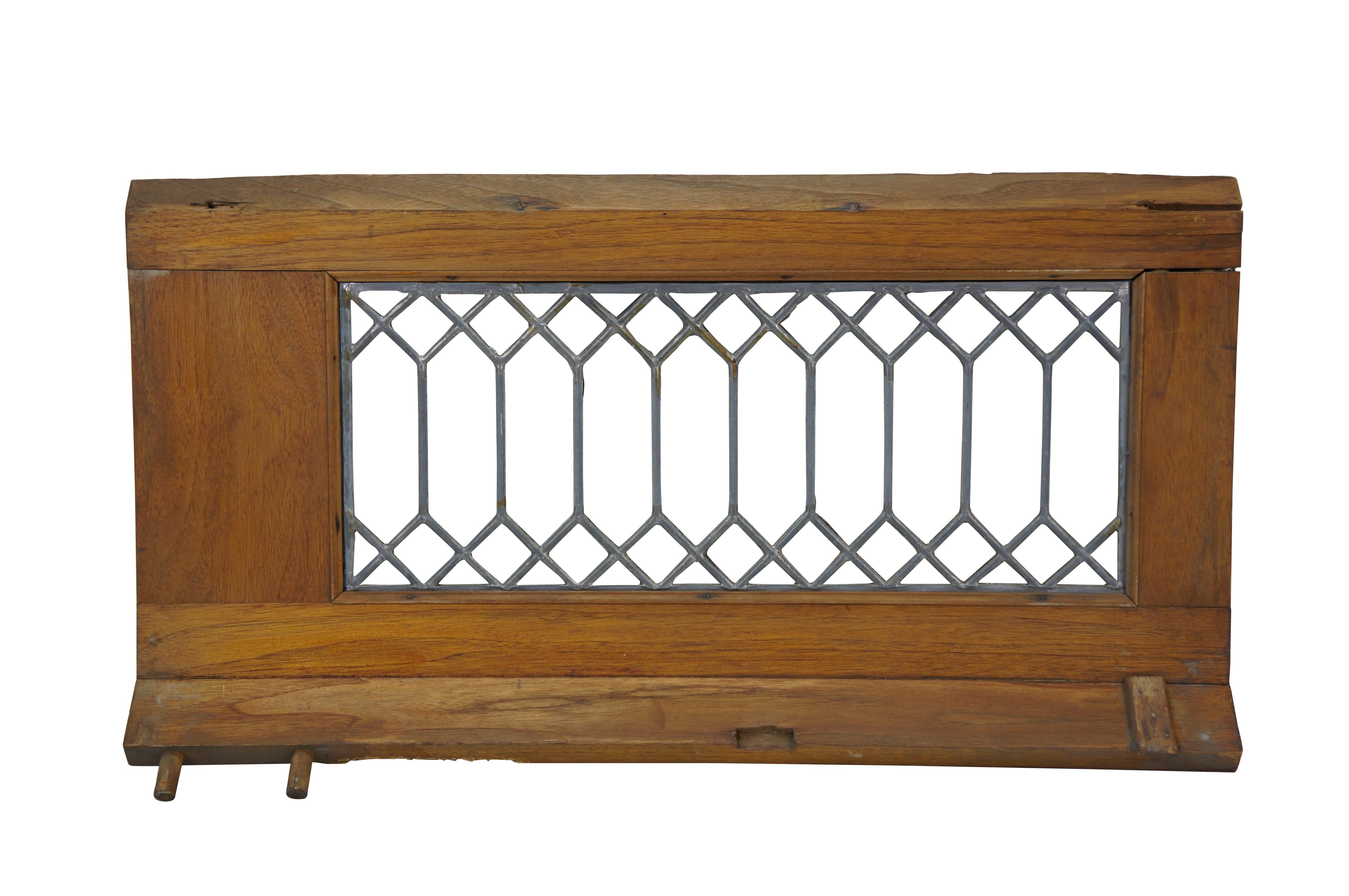 Pair of antique architectural salvaged rectangular transom / cabinet windows - oak frames with angled base; clear leaded geometric picket fence style glass. 

Dimensions:
23.5