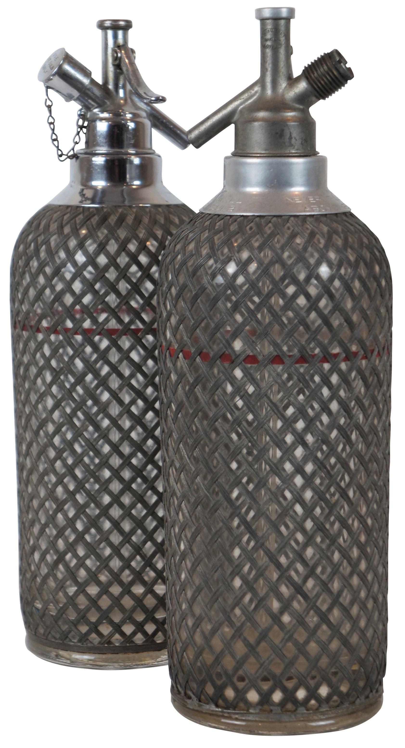 2 early 20th century art deco style Sparklets seltzer bottles or syphons, wrapped in a lattice of wire mesh. Glass marked along the bottom 