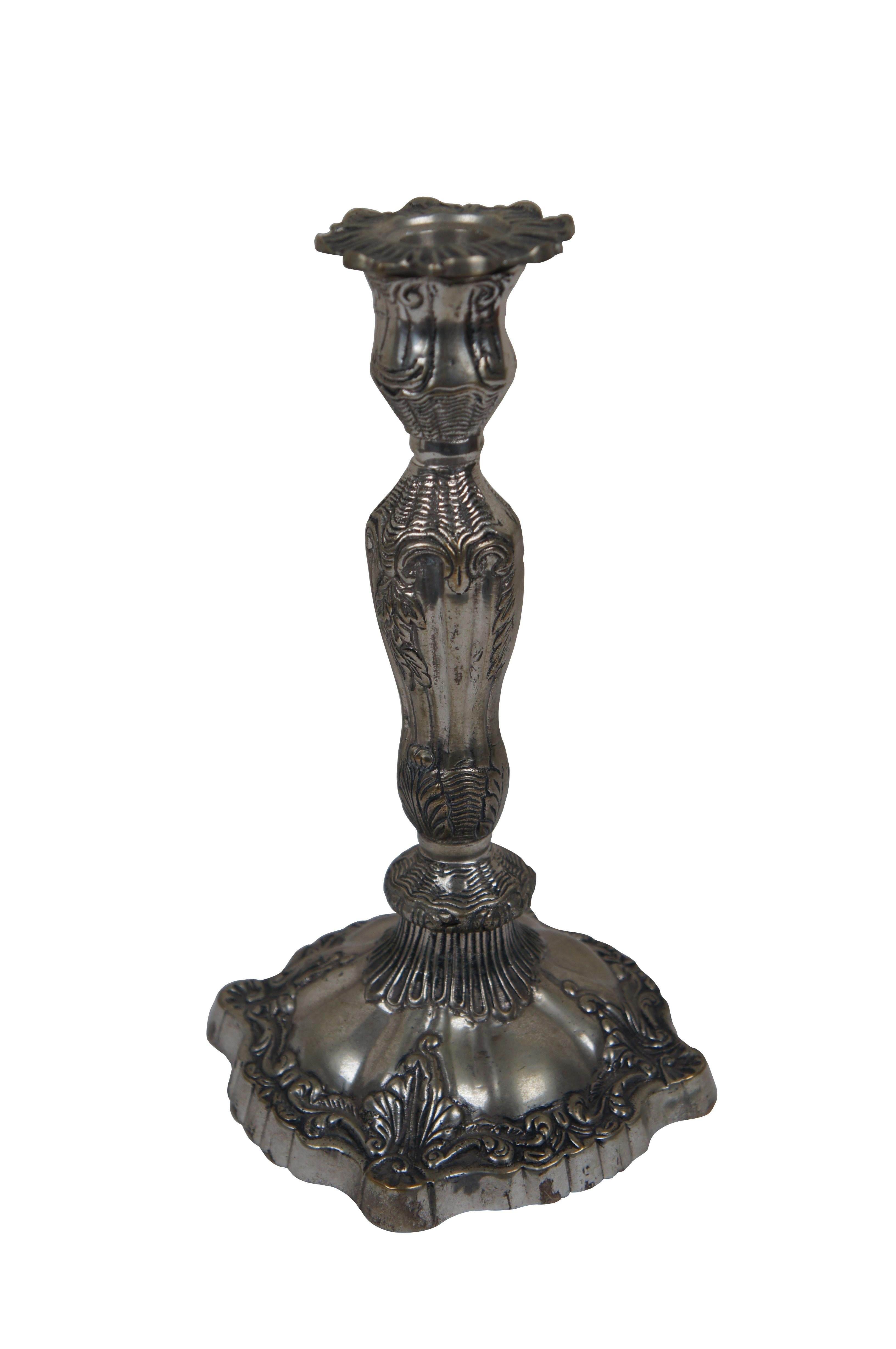 Pair of heavy late 19th to early 20th century Victorian silverplate candlesticks featuring flower petal candle cups and art nouveau scallop and foliate designs. 

Dimensions:
5.5