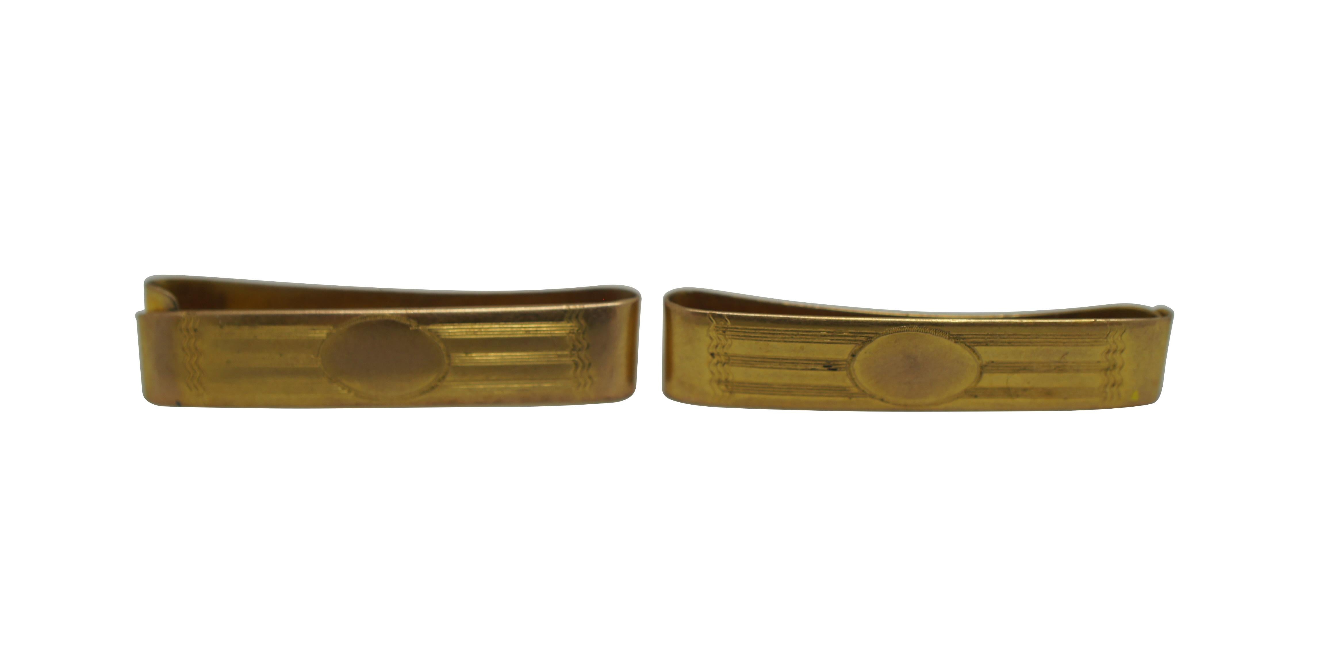 Pair of early 20th century Ballou & Co 10k yellow gold tie bar / clasps etched with a simple, classic motif of an oval backed with stripes and waving lines.

“Ballou & Company, Inc - Established circa 1868, Providence, Rhode Island. Registered circa