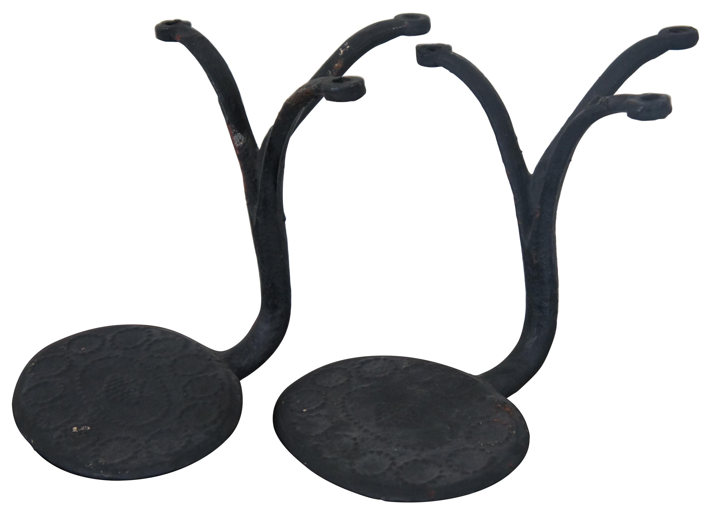 Pair of antique round cast iron horse drawn carriage steps with a low relief geometric stamped diamond pattern and tripod support. Measure: 10
