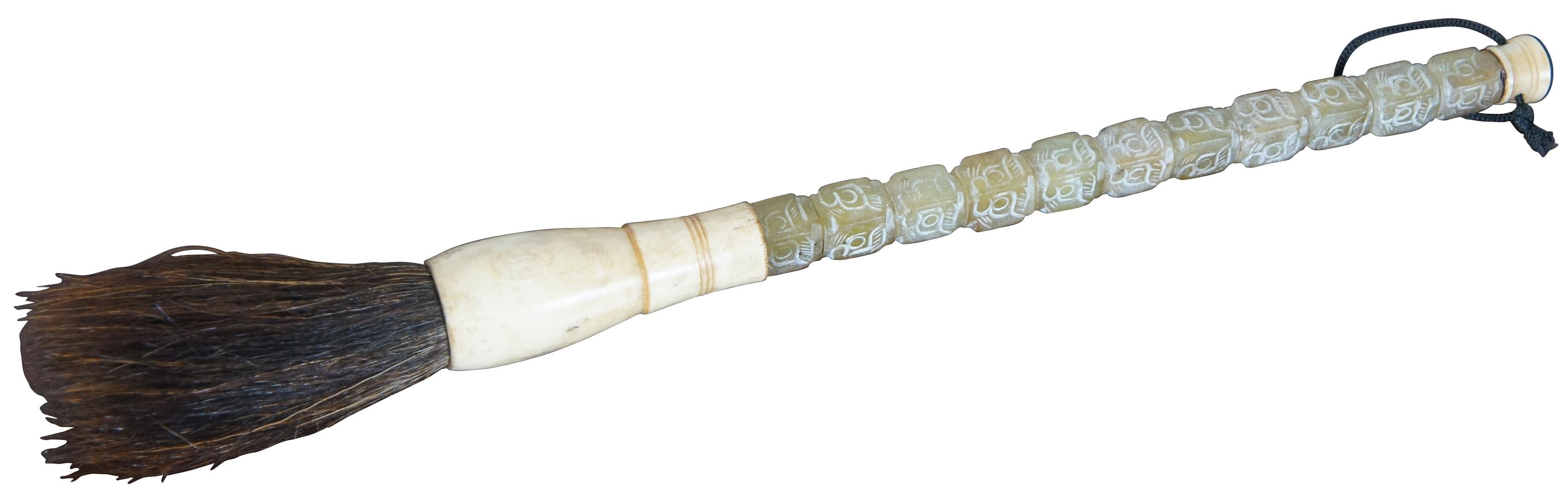 Pair of antique Chinese calligraphy brushes with horsehair bristles and carved Jade handles.

Soapstone - 1.5 x 12.5 / Agate – 1” x 11” (diameter x length).