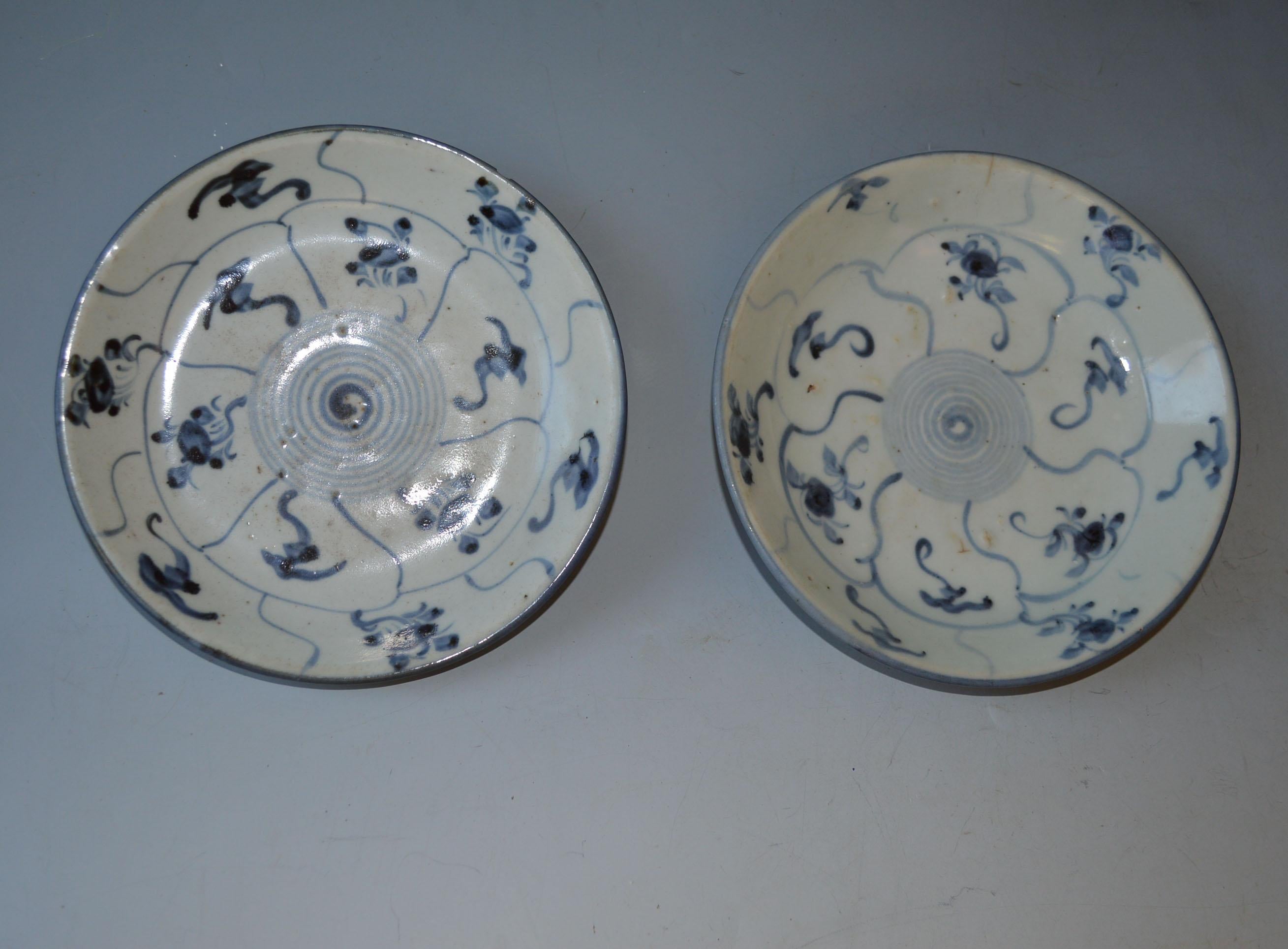 2 Antique Chinese provincial porcelain plates ming dynasty circa 16th century 
Hand painted heavy porcelain with a pleasing central spiral motive with floral and swirling designs in cobalt blue on white, in a rather naïve form typical of Chinese