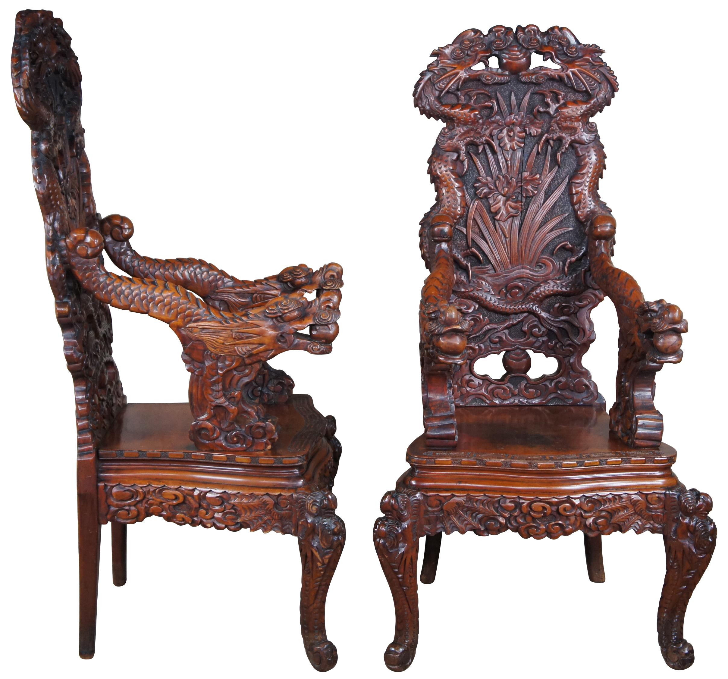 A breathtaking pair of 19th century imperial meiji throne chairs. Made from Elm with an elaborate and meticulous carved dragon motif. At the center are a pair of orchids flanked by sprawling dragons which can be seen sharing a ball or pearl along