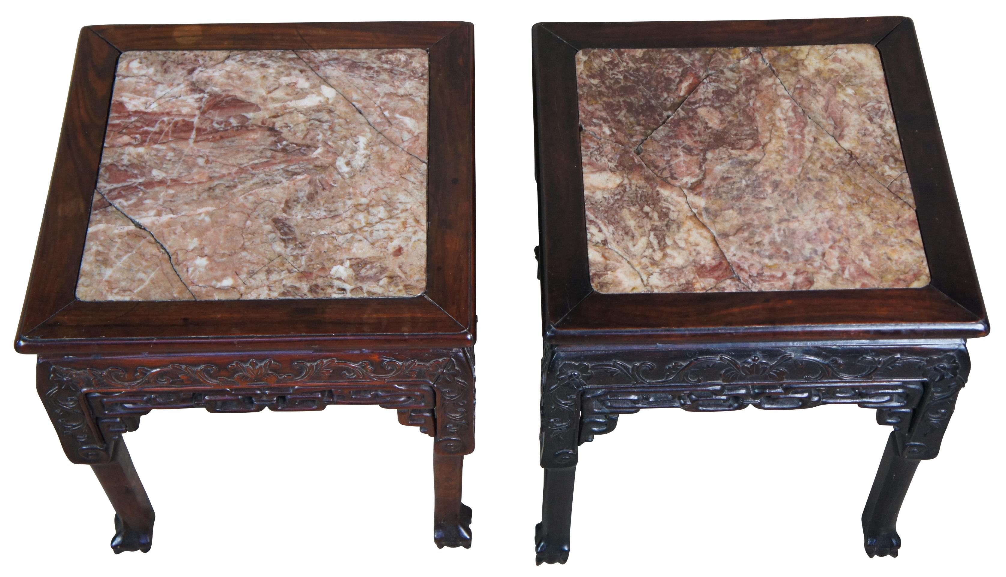 Pair of antique 19th century Chinese tables or plant stands. Made of carved rosewood featuring square form with floral and reticulated designs, pink marble, and ball and claw feet.
    