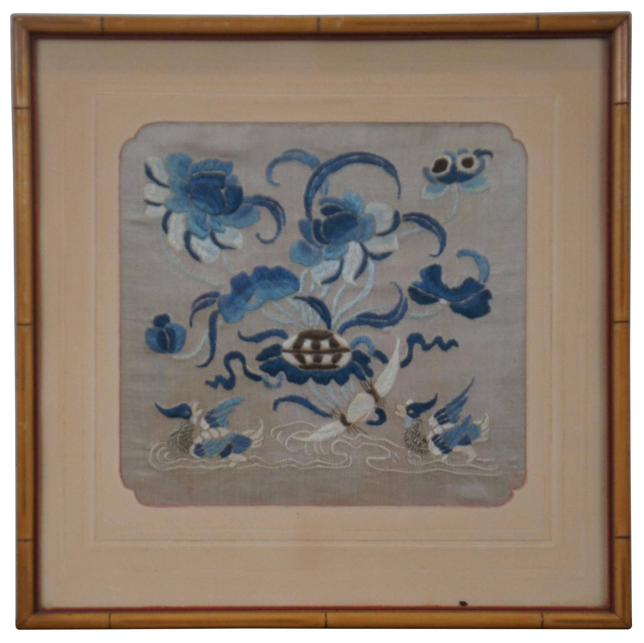 Pair of antique Chinese Qing Dynasty silk textile / tapestry court rank military buzi badges or panels embroidered with a scene Mandarin Ducks and blue flowers. Framed in faux bamboo.

A mandarin square, also known as a rank badge, was a large