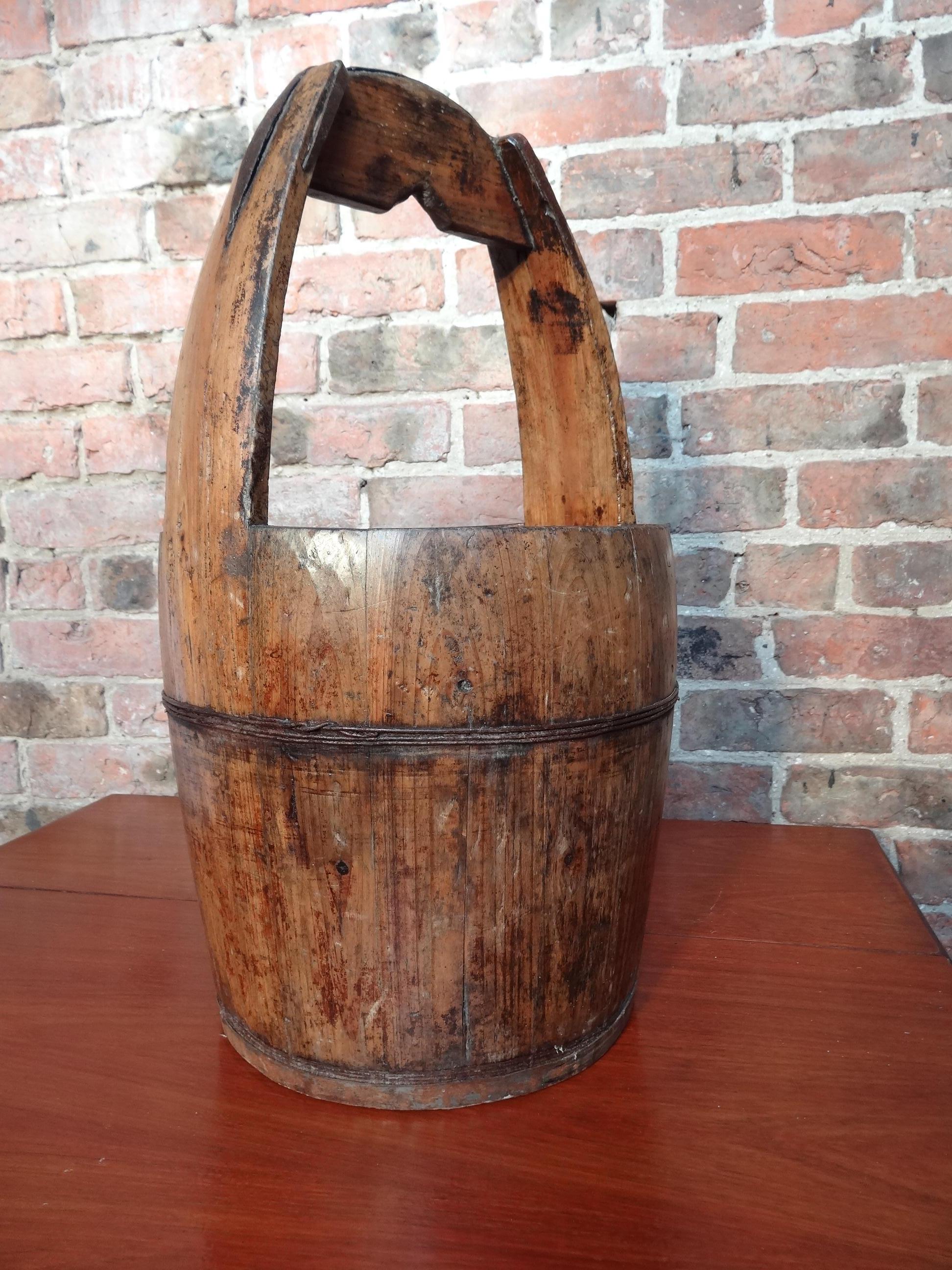 2 antique Chinese water bucket in dark and light wood

Measures: Height: 58cm, depth: 34cm, width: 34cm.