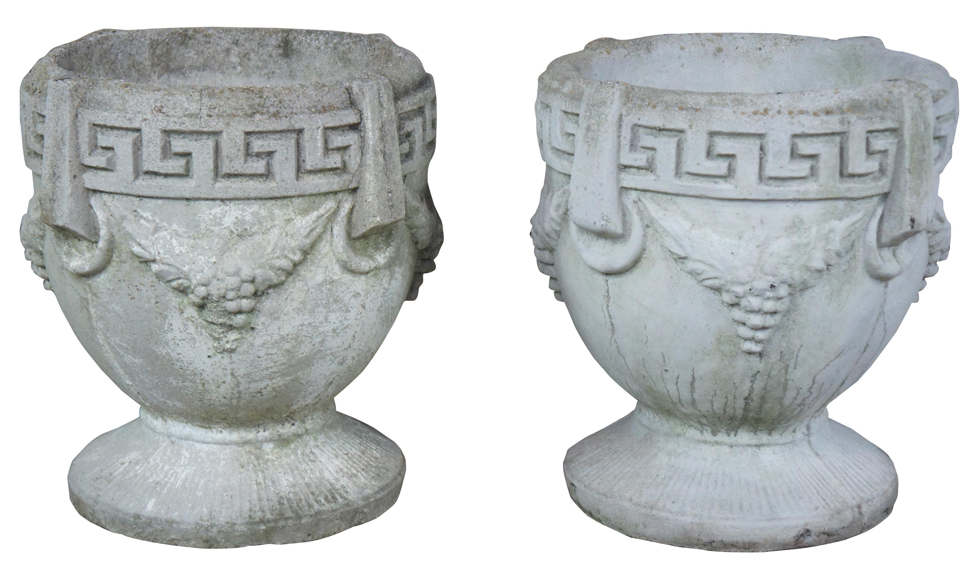 Pair of two antique Grecian urns or planters. Features Greek Key rim and grape design. Very heavy.
   