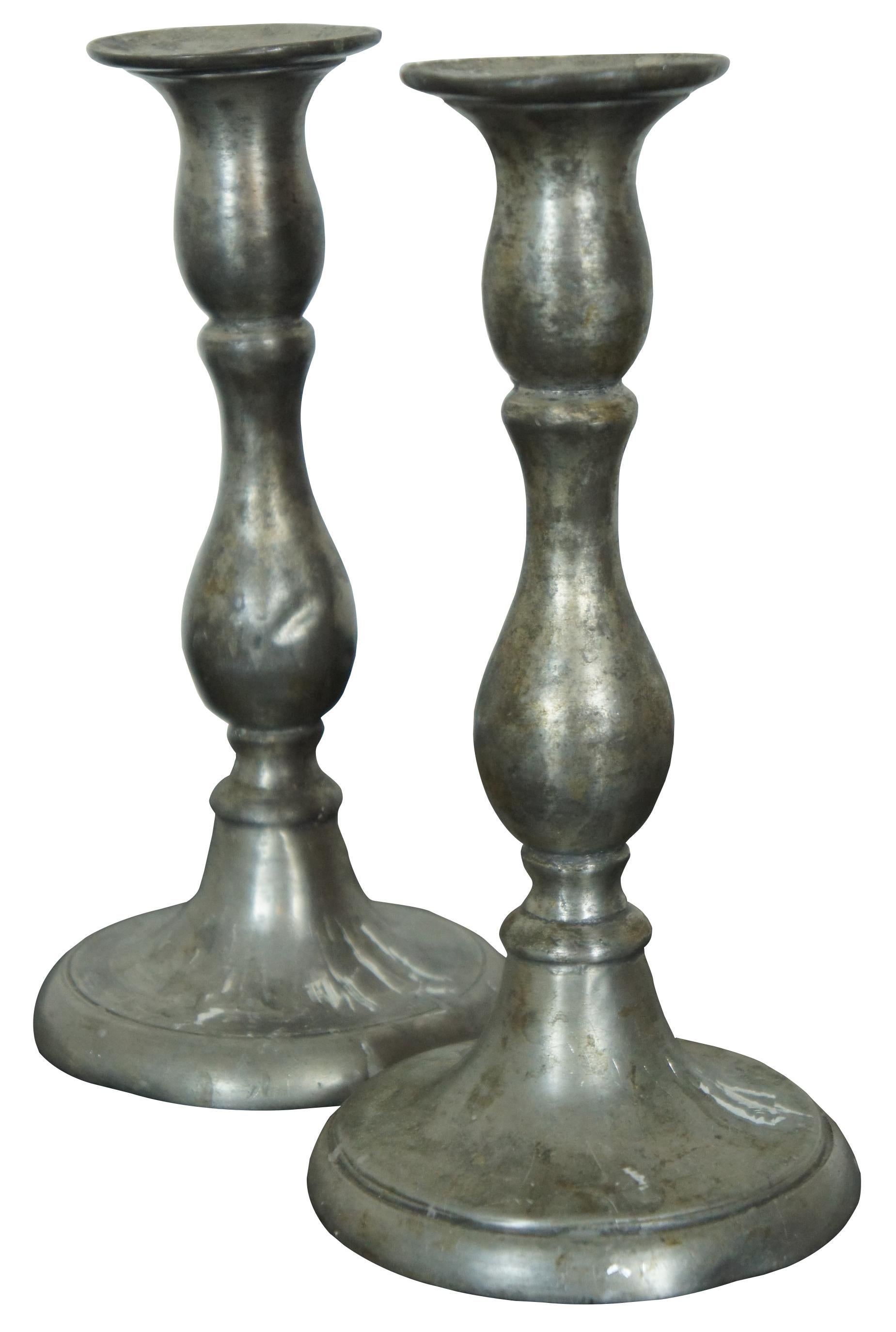 Pair of antique early American baluster style pewter candlesticks.
