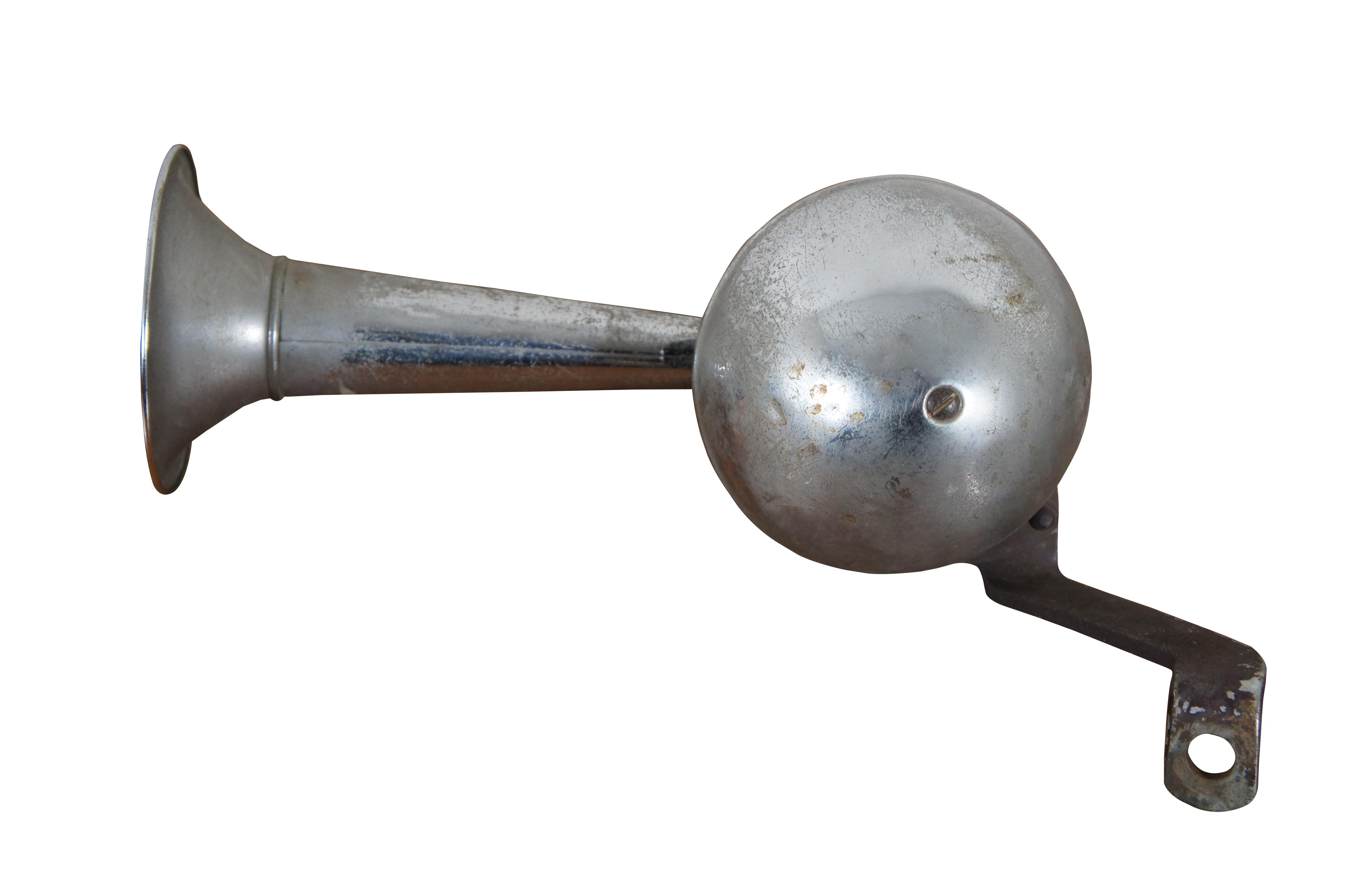 Pair of early to mid 20th century automobile or boat horns with compact trumpets and half round casing on mechanism.  Originally removed from an old Rolls Royce.

Dimensions:
8.25