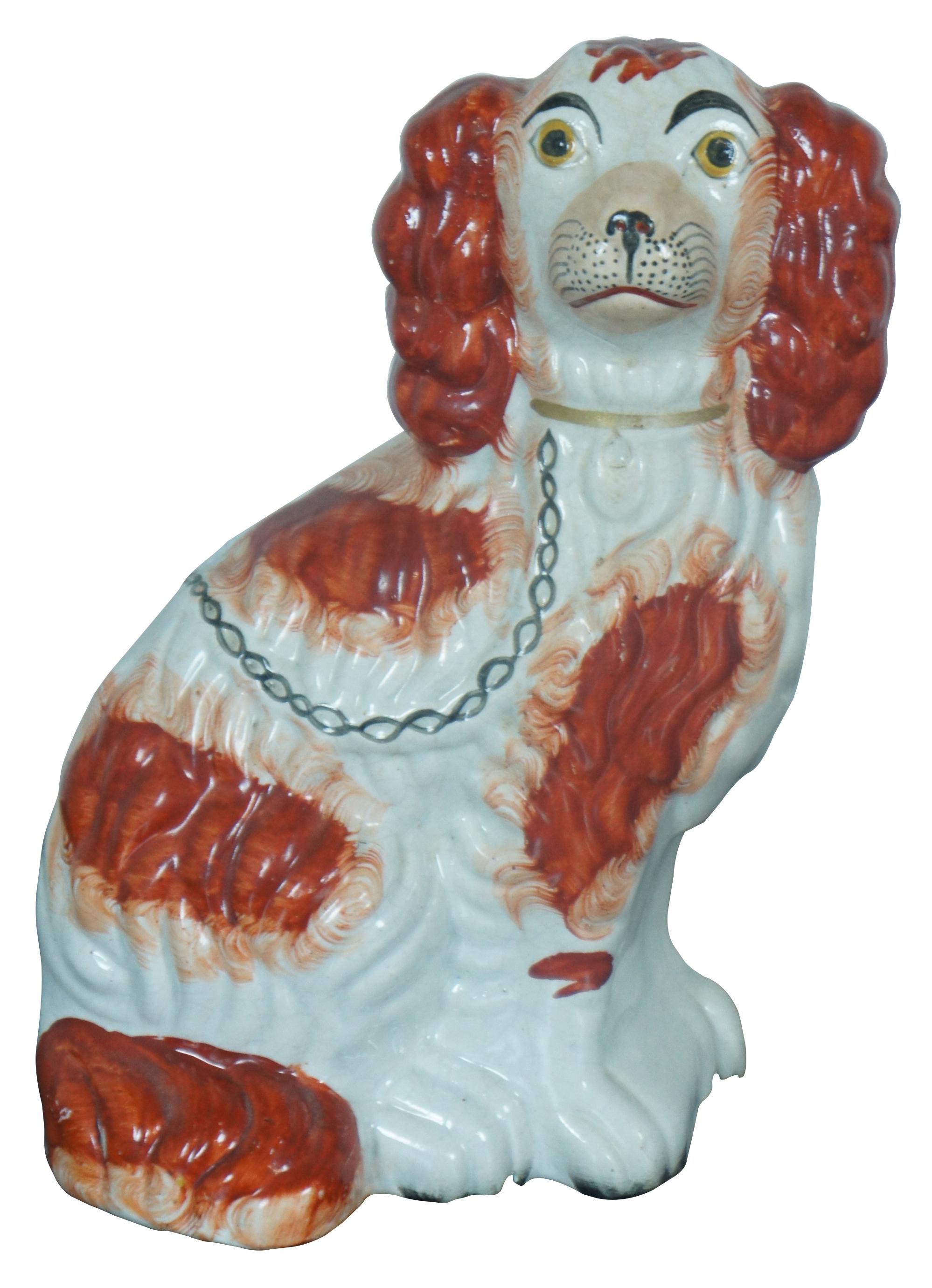 Pair of antique Staffordshire porcelain red and white King Charles Spaniel sculptures with gilded collars and chains. Circa last quarter 19th century, incised with a #2 along the base.  Measure: 10