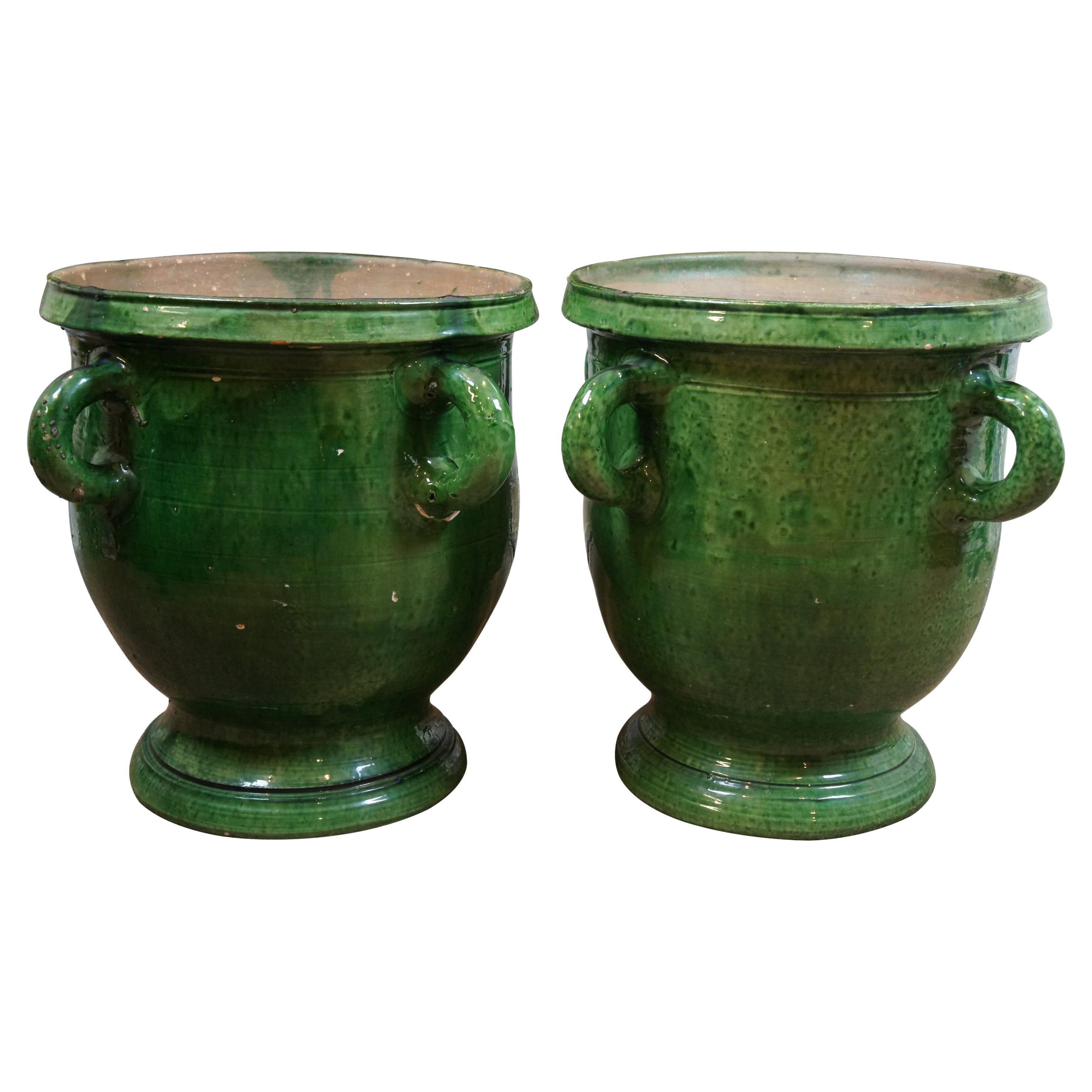 Early French green glazed Terracotta earthenware garden planter.   Wide trophy urn shape with drain hole, footed base and four lobed handles.  Handmade in France.

Dimensions:
21