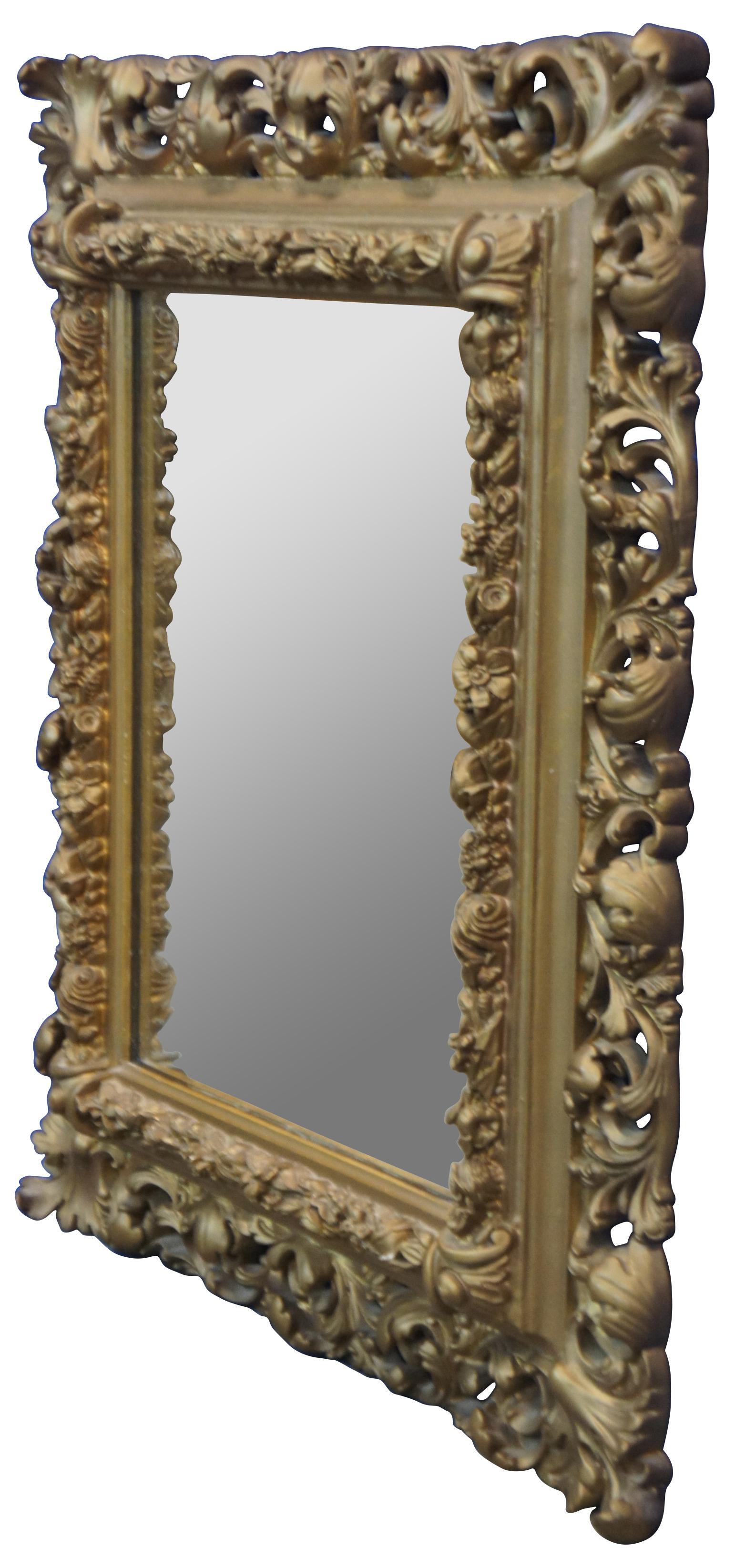 Pair of Antique French Baroque / Rococo gilt mirrors with rectangular form featuring molded frames decorated with small pierced or reticulated flowers and large swirling leaves.

Measures: 19.5” x 2” x 23” / Mirror - 11.5” x 14.75” (Width x Depth
