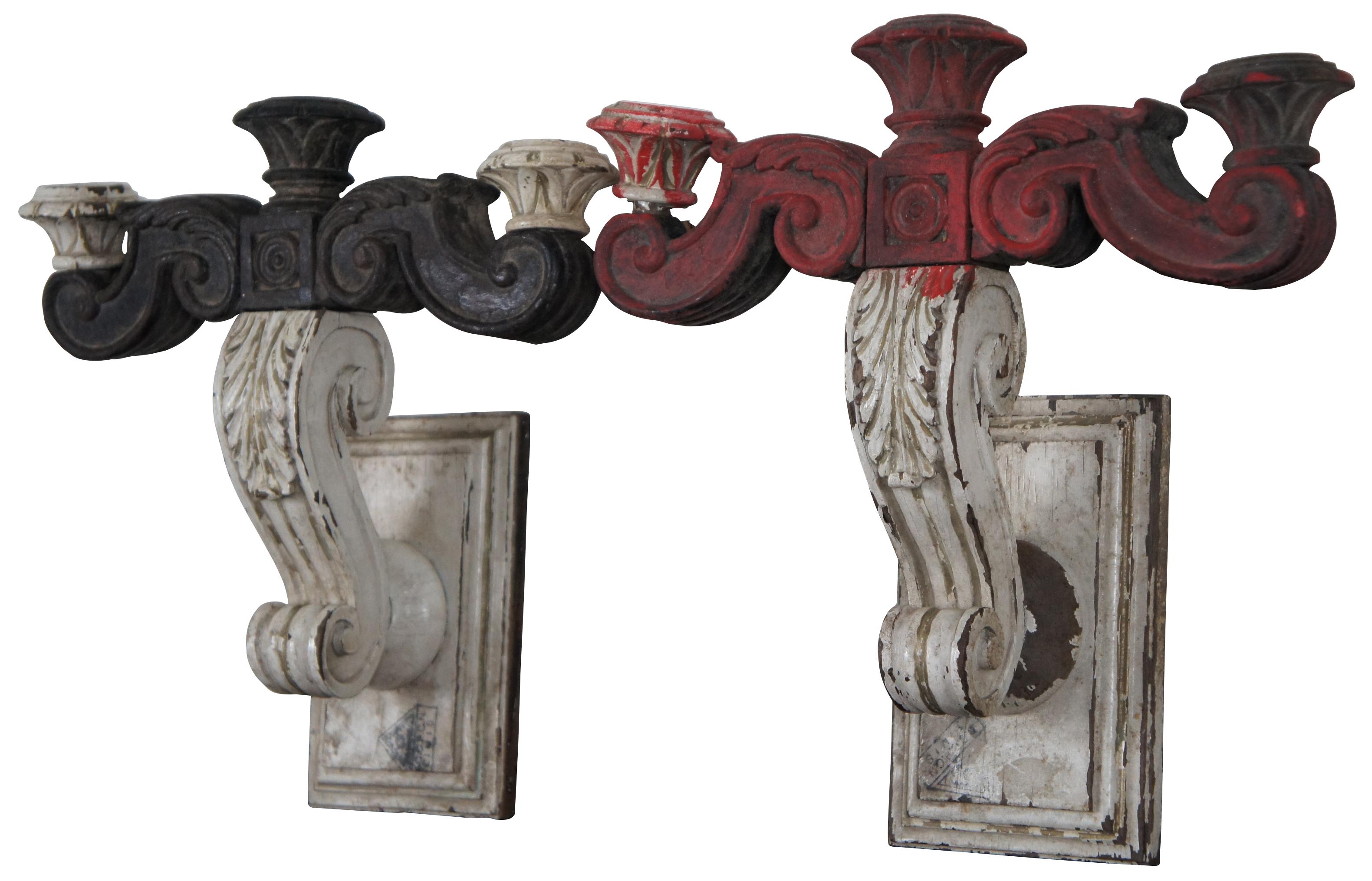 Pair of antique carved wood three arm candle holder wall sconces painted in red and white.
 