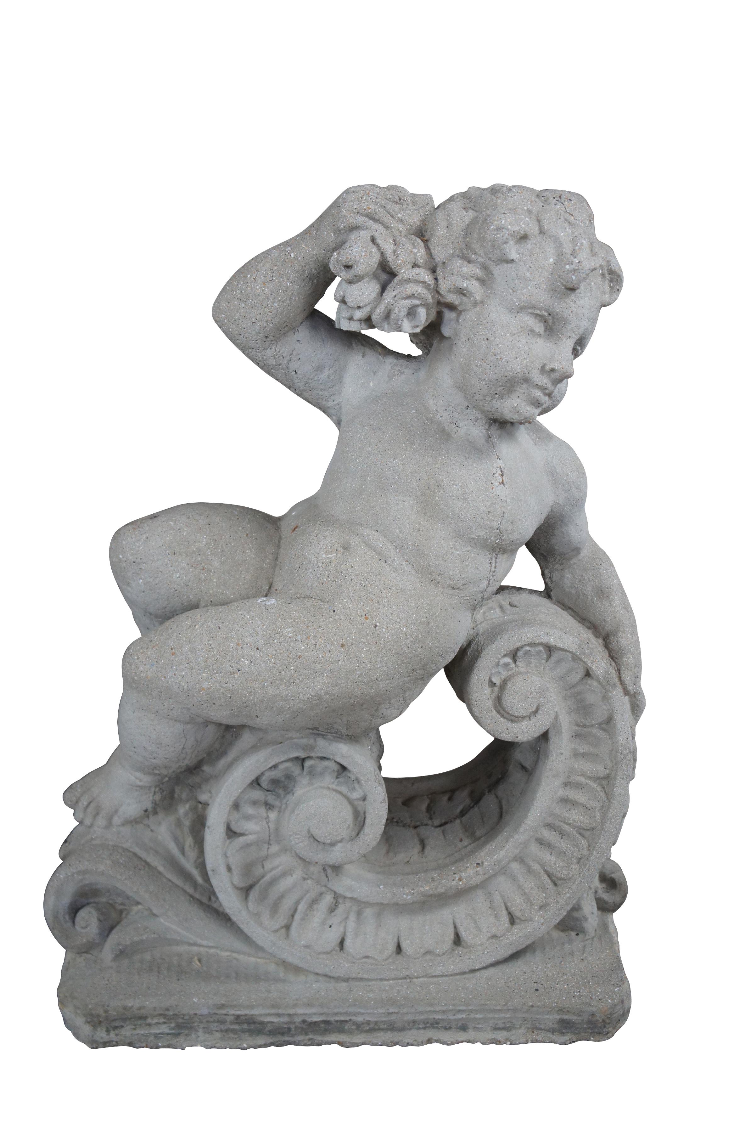 Pair of antique classical French putto / cherub statues representing two of the four seasons.  Made of concrete / stone featuring two reclining figures, one left facing with wheat and the other right facing with grapes.  Both figures sit on a