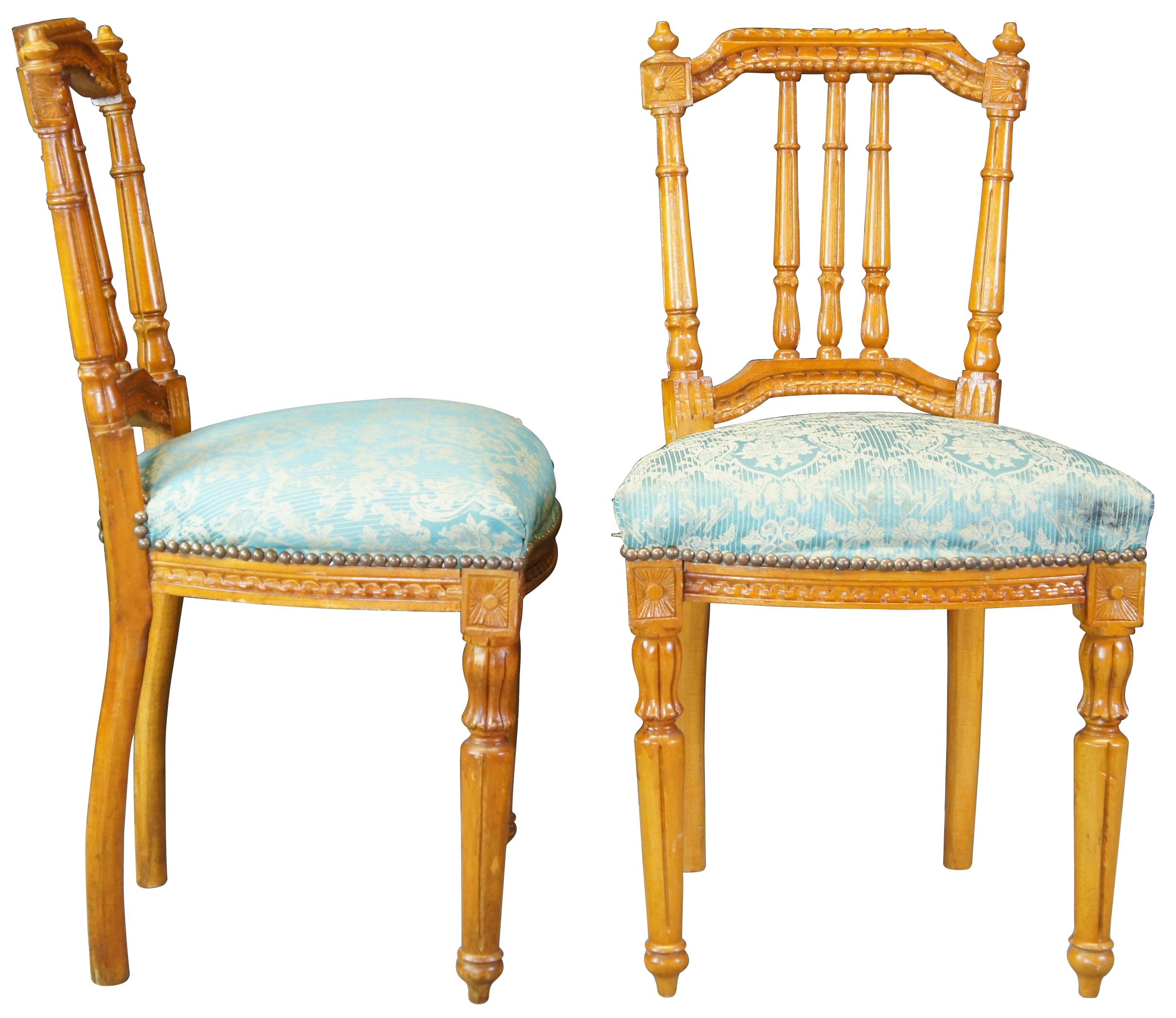Two French Louis XVI side accent chairs featuring ornate carvings with turned and fluted accents and needlepoint seat. Circa first half 20th century.
 