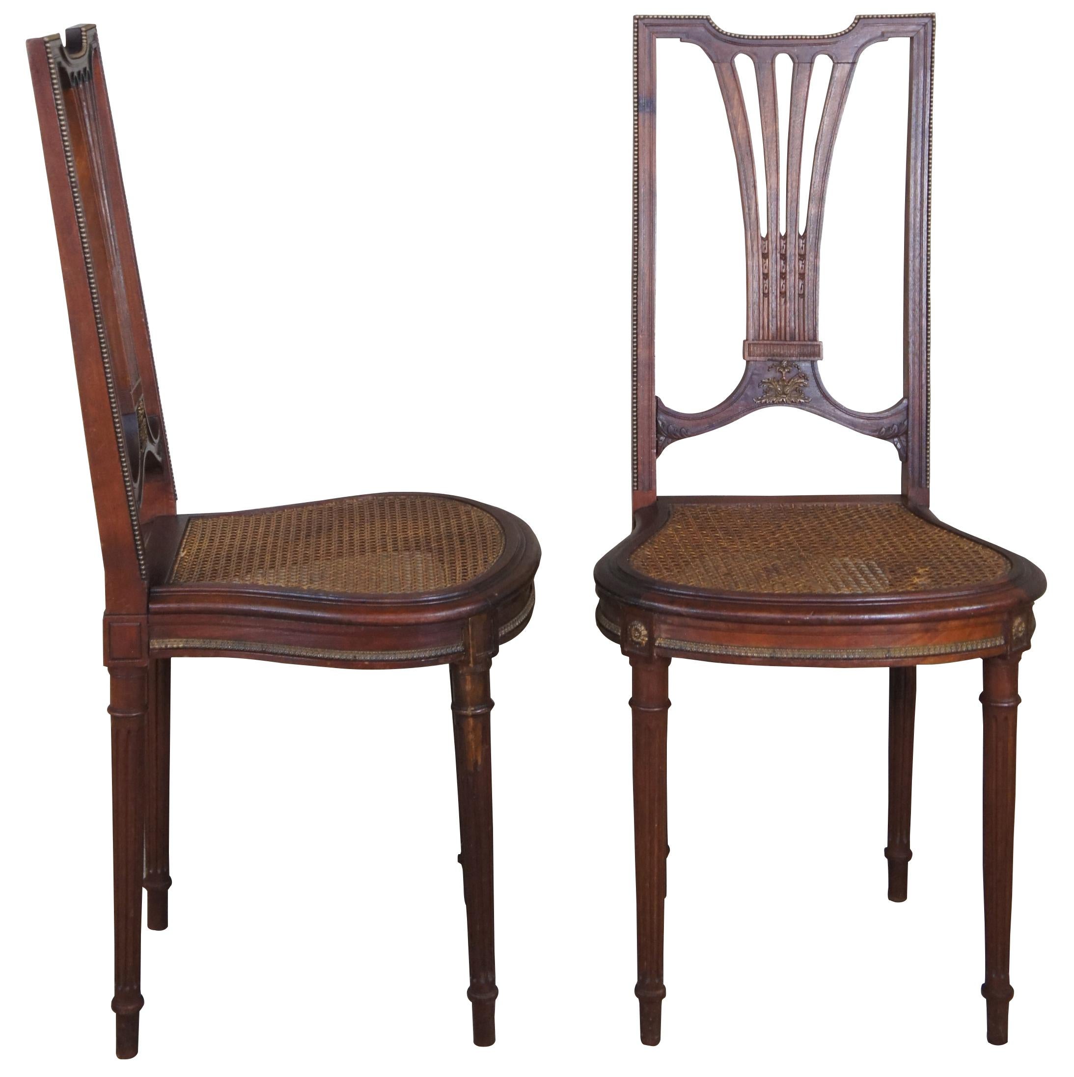 An elegant pair of Louis XVI petite side chairs, circa 1870s. Made from solid walnut with a high back featuring pierced splat and caned seat. The chair includes a beaded bronze framework that follows the contour of the seat back. Complimented by