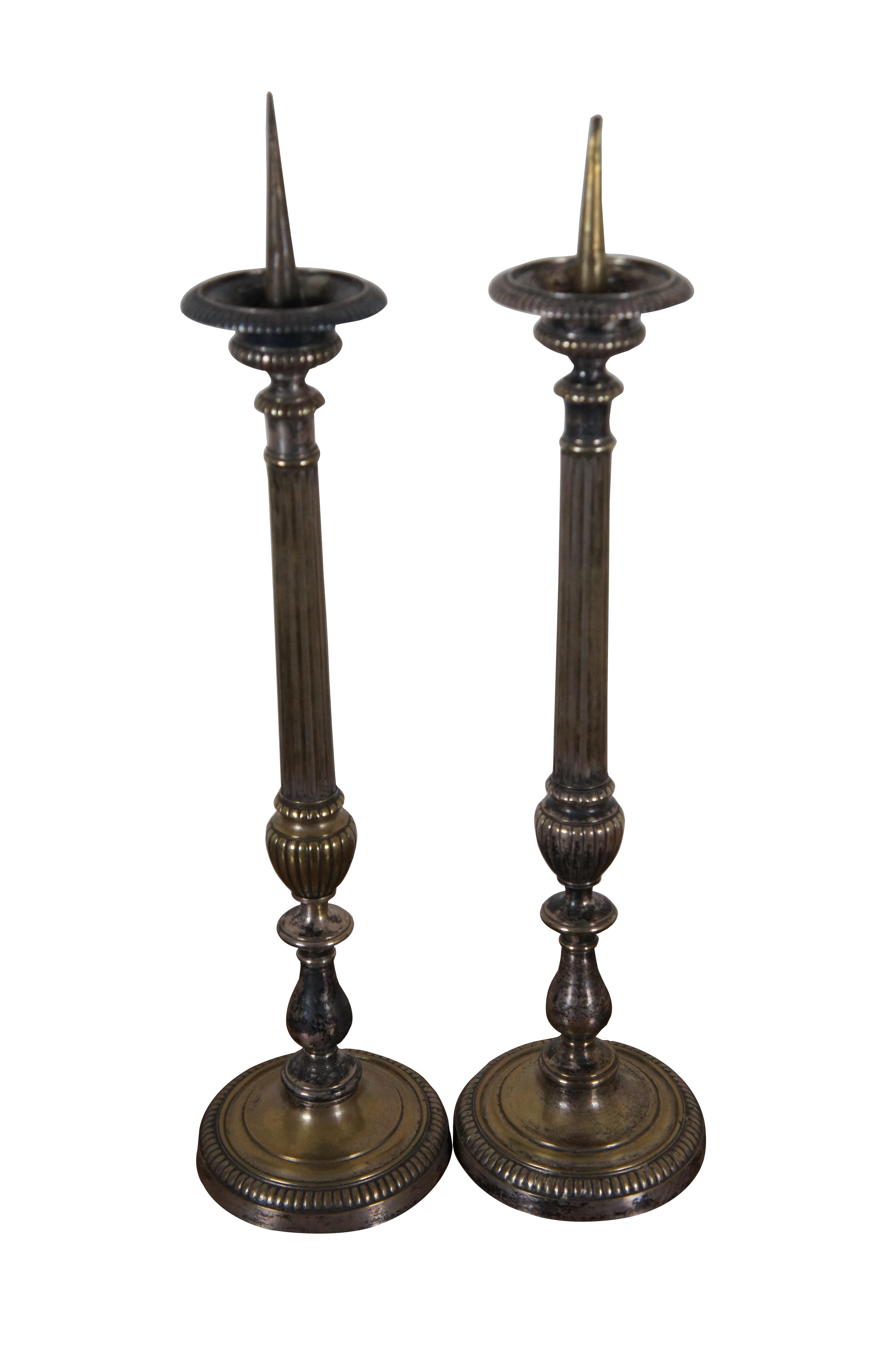 Two antique French Louis XVI style silverplate mantel or floor prickets / candlesticks / candle holders featuring a tall reeded column with trophy urn form pedestal base.

In the history of religion, light and fire have frequently accompanied the