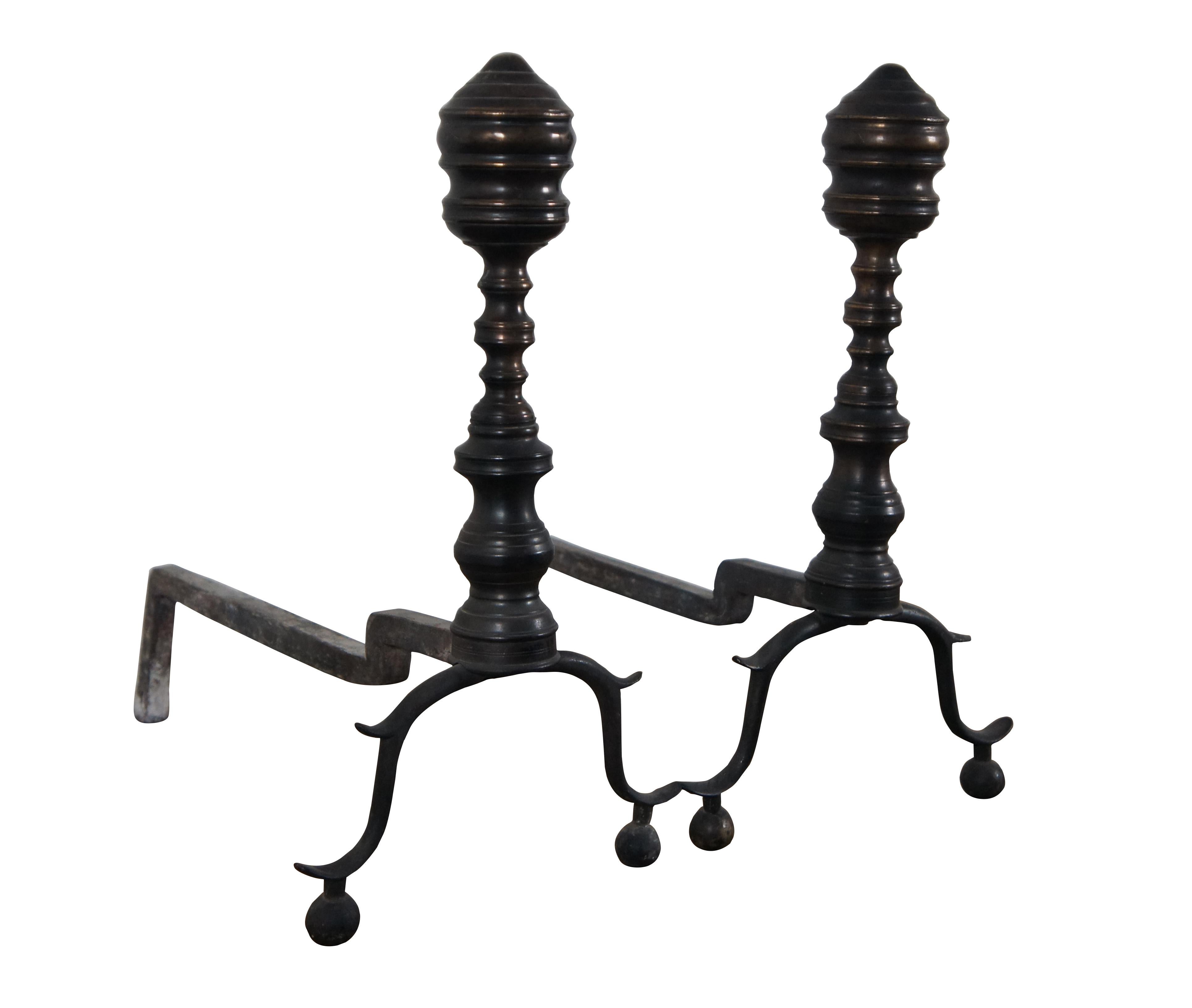 Pair of late 18th / early 19th century antique wrought iron and brass andirons / fire dogs featuring Colonial or Georgian styling with bow legs and a lovely dark patina.

Dimensions:
9