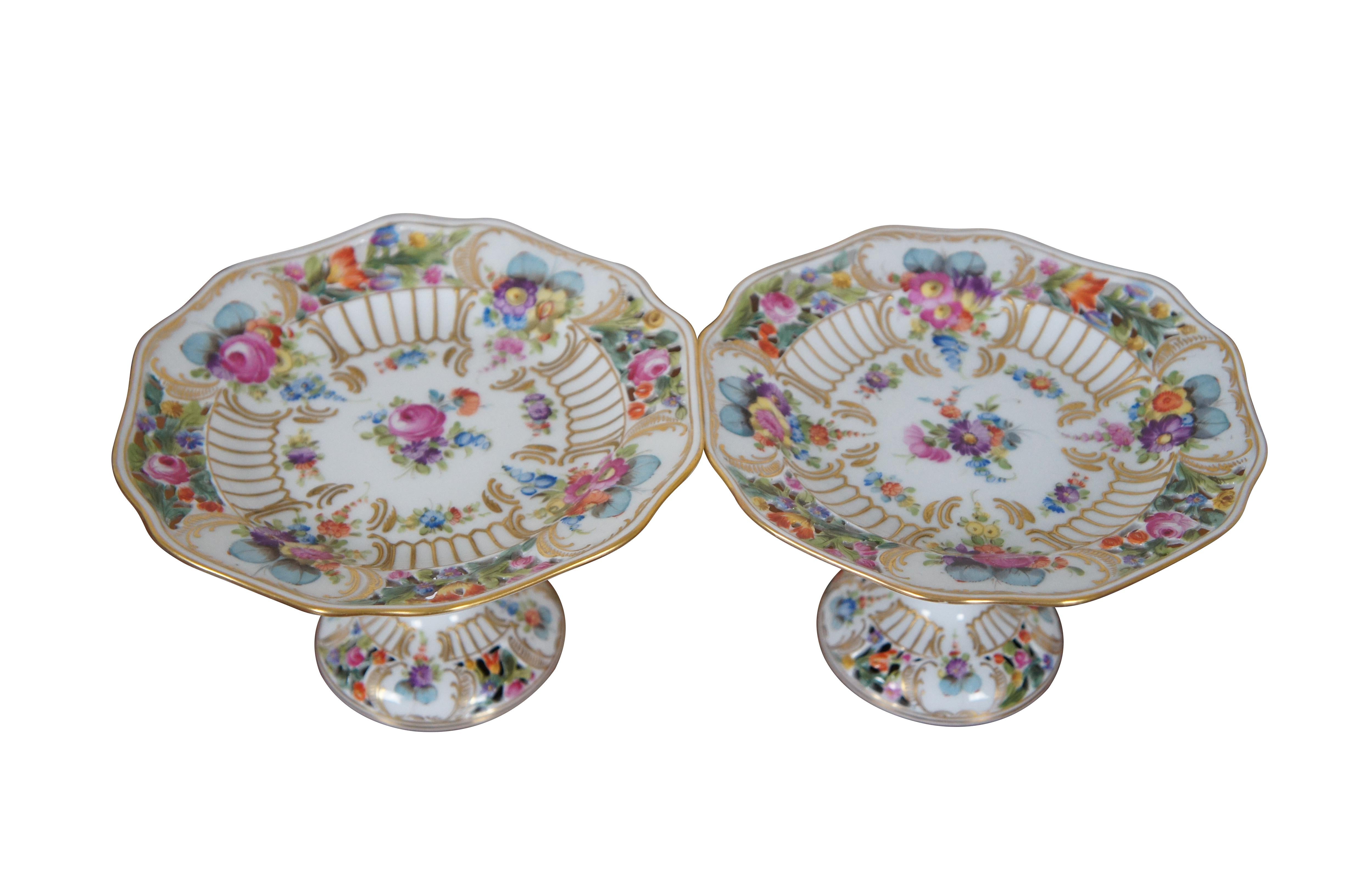 Pair of two antique German Dresden Carl Thieme porcelain compotes / cake / dessert plates / stands featuring a floral theme with scalloped form, pedestal base and reticulated / pierced accents.  Marked Dec: 300. Depose.  Cirac 1902-1920.

“The