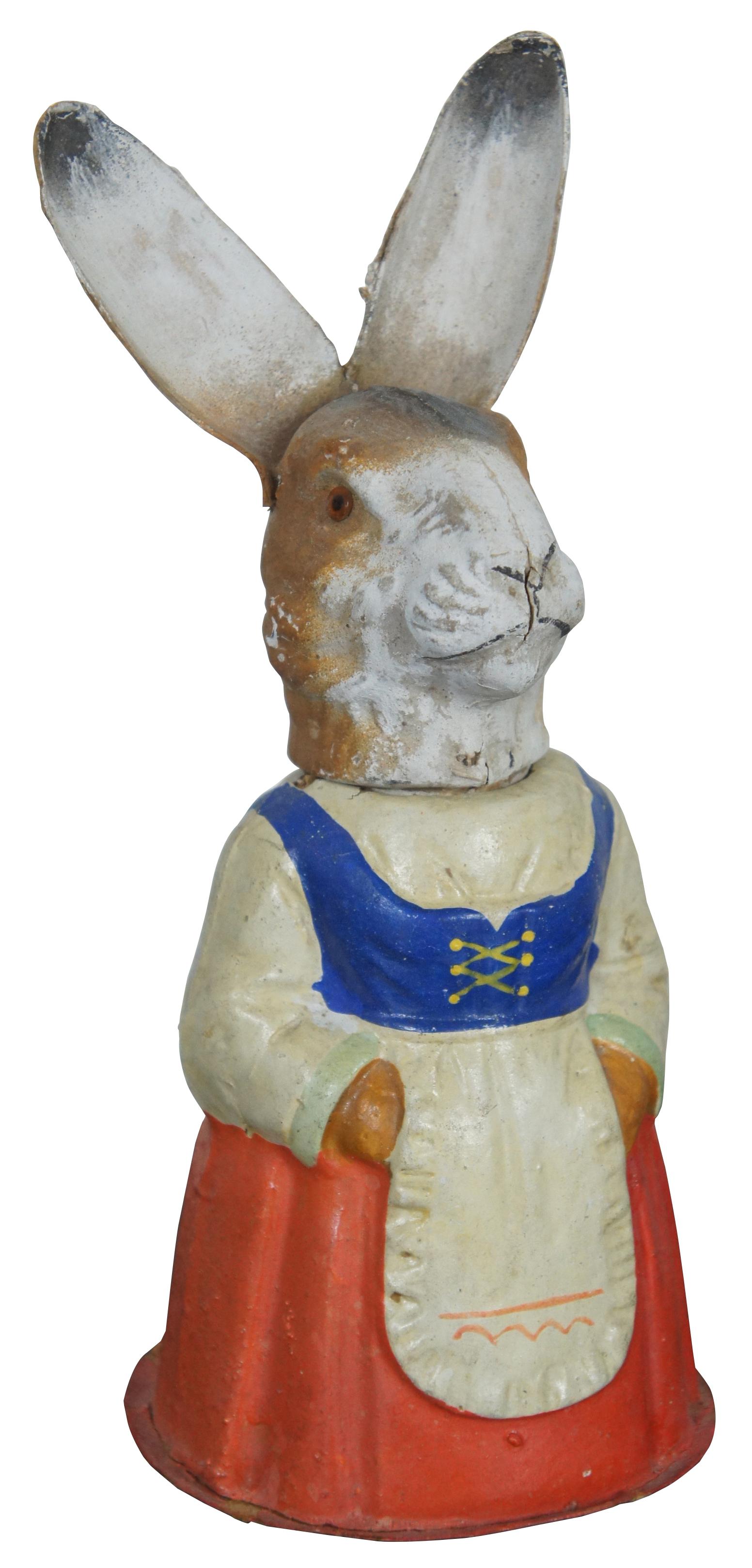 Pair of antique German paper mâché, painted folk art rabbit / Easter bunny Mr. & Mrs. figurines candy containers dressed in red, yellow and blue outfits and housed in a wood and glass display case.

Measures: Case: 12.5” x 7” x 12.25” / Rabbits: