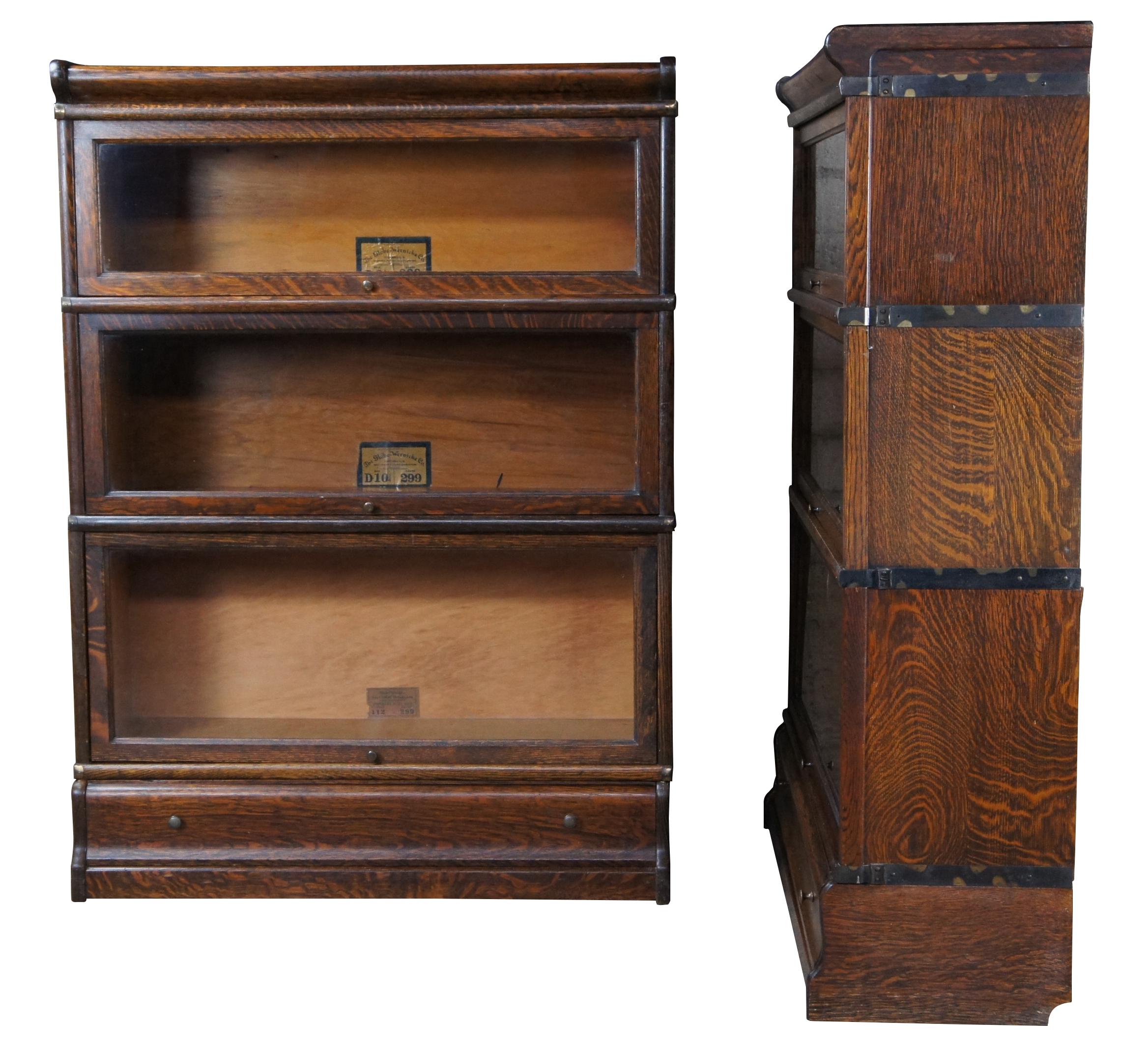 Two antique Globe-Wernicke Mission oak stacking library / lawyer curio bookcases or barrister cabinets. Made in Cincinnati Ohio. Features stackable units of 8.5