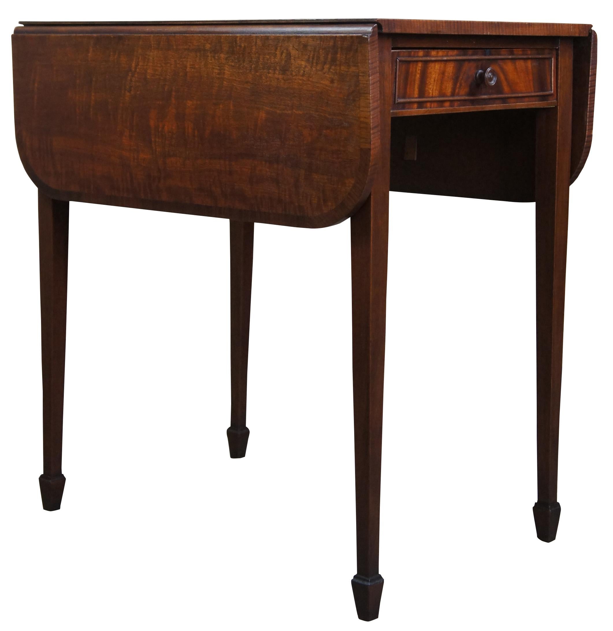 A stunning pair of antique drop leaf end tables by Imperial Furniture Co. Imperial operated out of Grand Rapids, Michigan between 1903-1954. Made from genuine mahogany in sheraton styling with spade feet. Each piece features a flame mahogany front