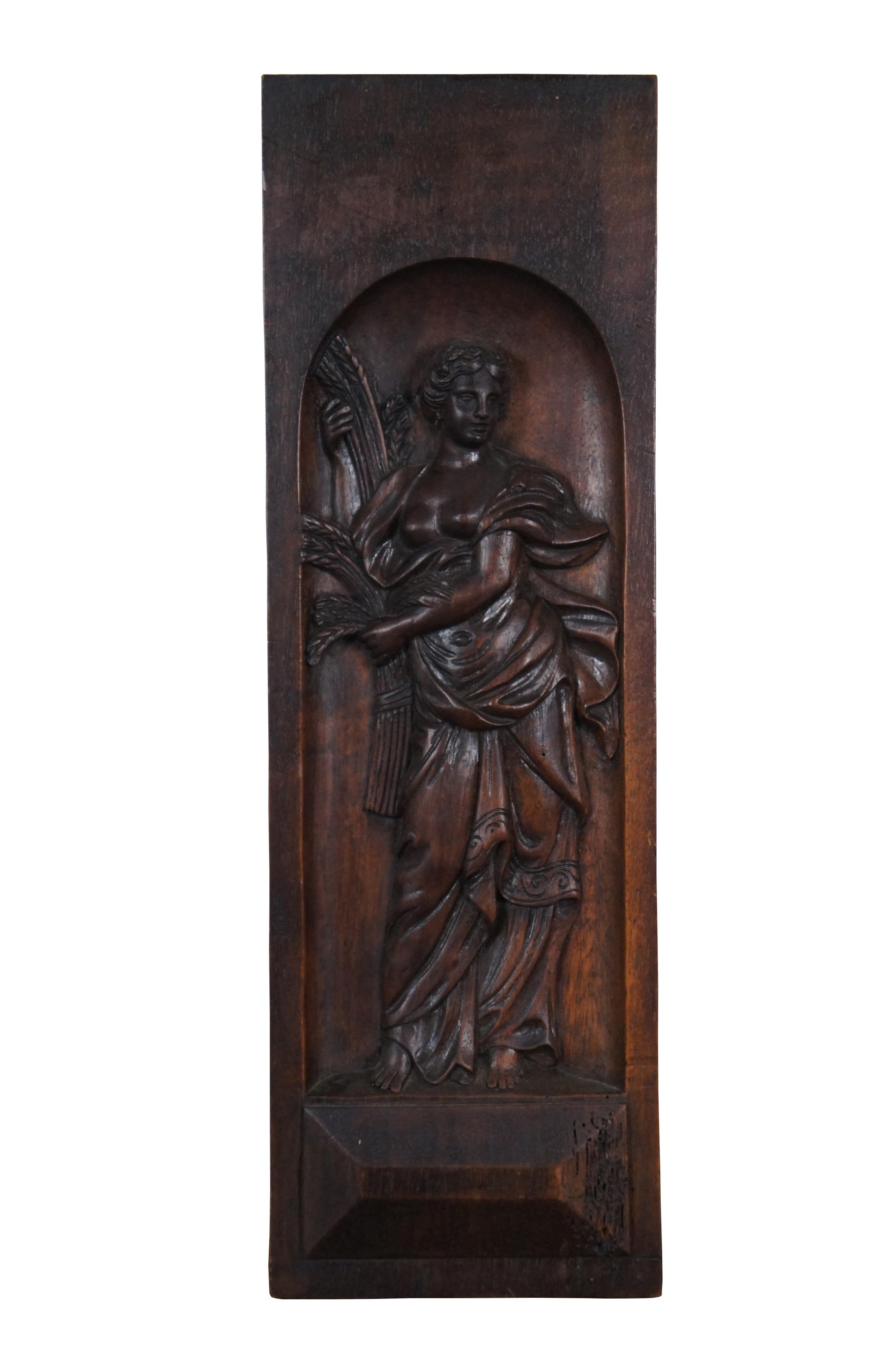 Pair of antique hand carved walnut bas relief panels / wall plaques, showing Neoclassical female figures, one holding sheaves of wheat and the other holding flowers.

Dimensions:
6.5