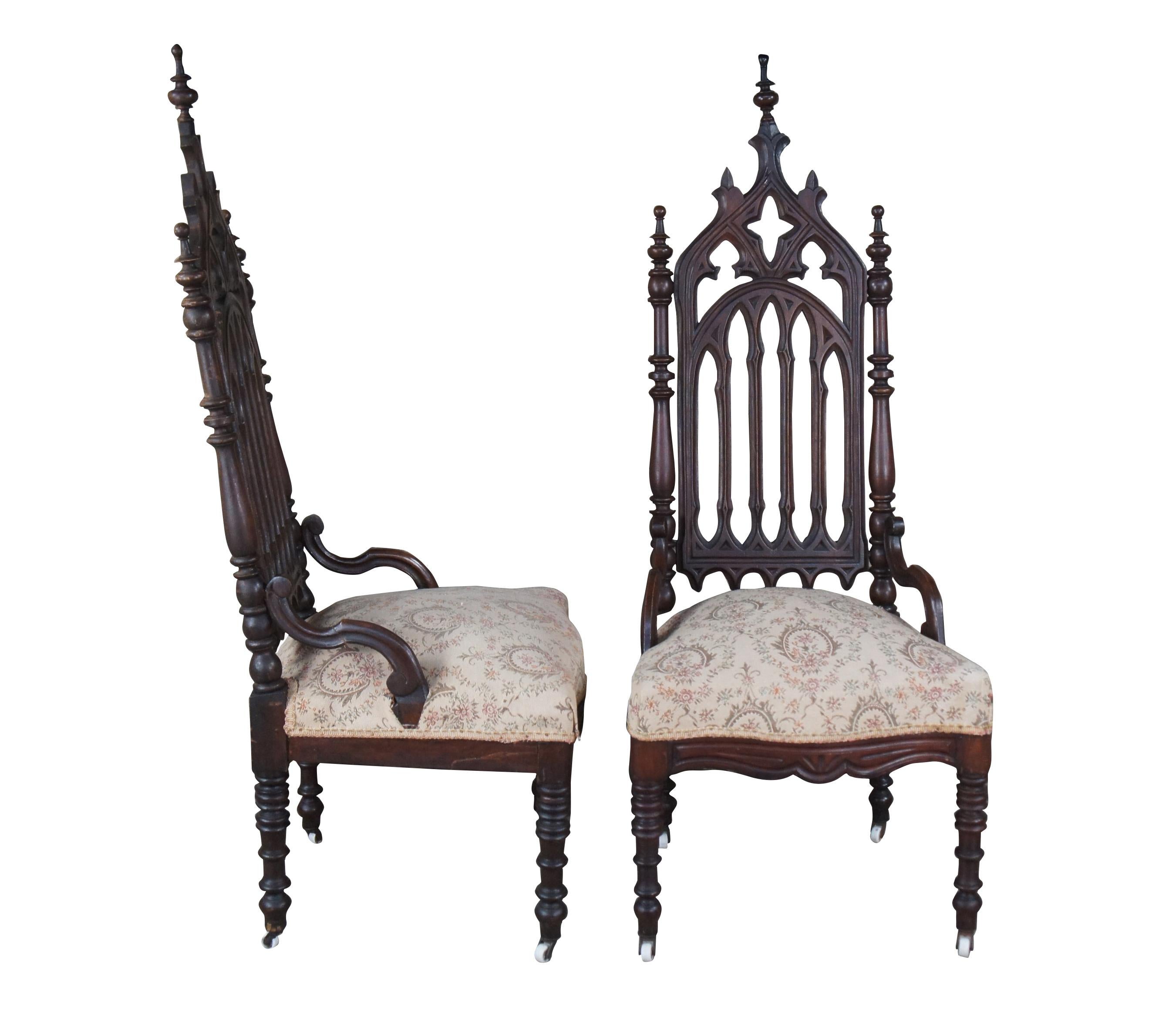 A pair of impressive Gothic / Renaissance revival occasional armchairs featuring ornate high relief pierced design with turned legs and posts over casters.

The Gothic Revival style is part of the mid-19th century picturesque and romantic movement