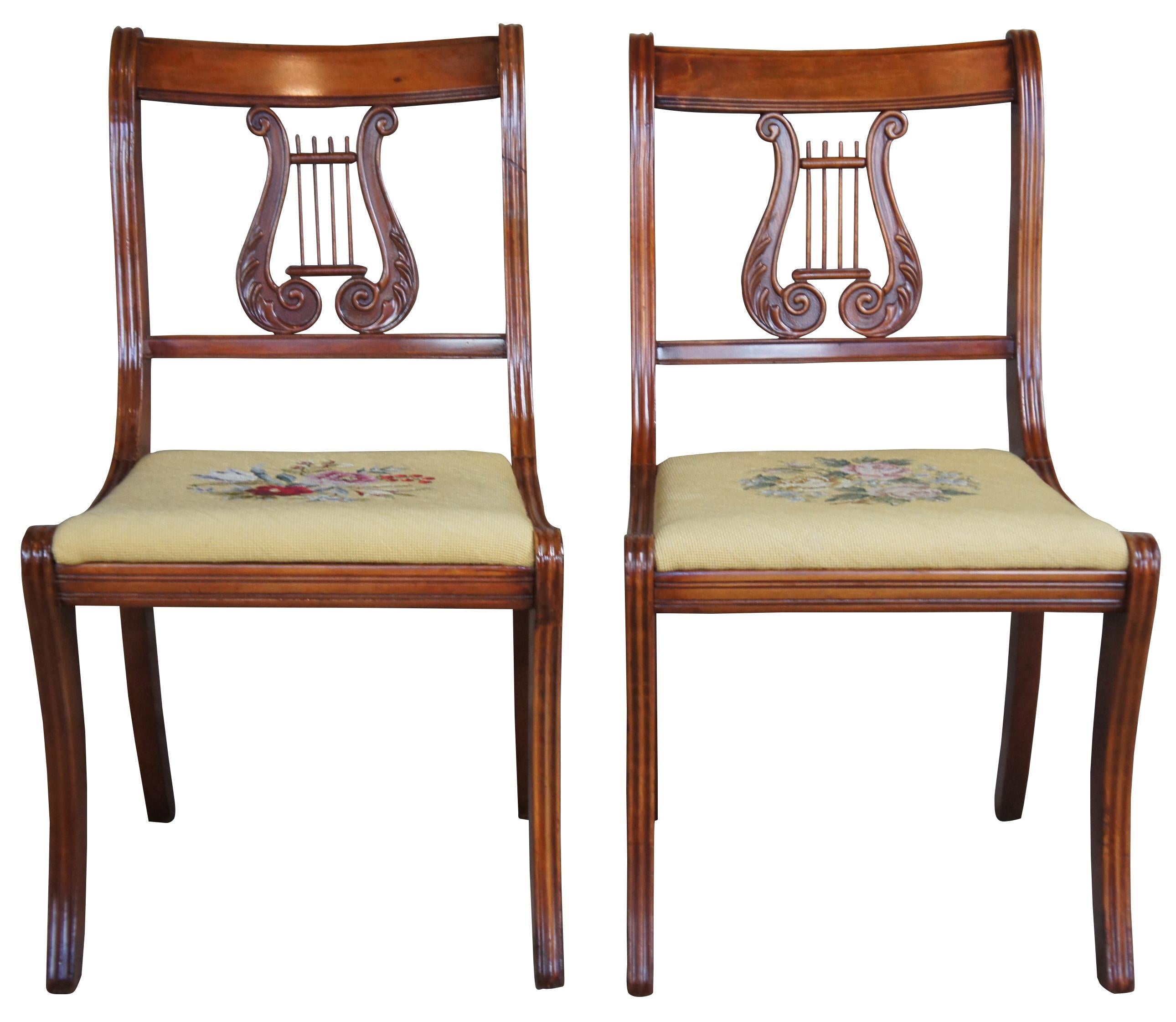 Pair of two antique R.H Macy & Co. side chairs, circa 1900s. Made of cherry, featuring a yellow floral needlepoint embroidered seat and harp back.
   