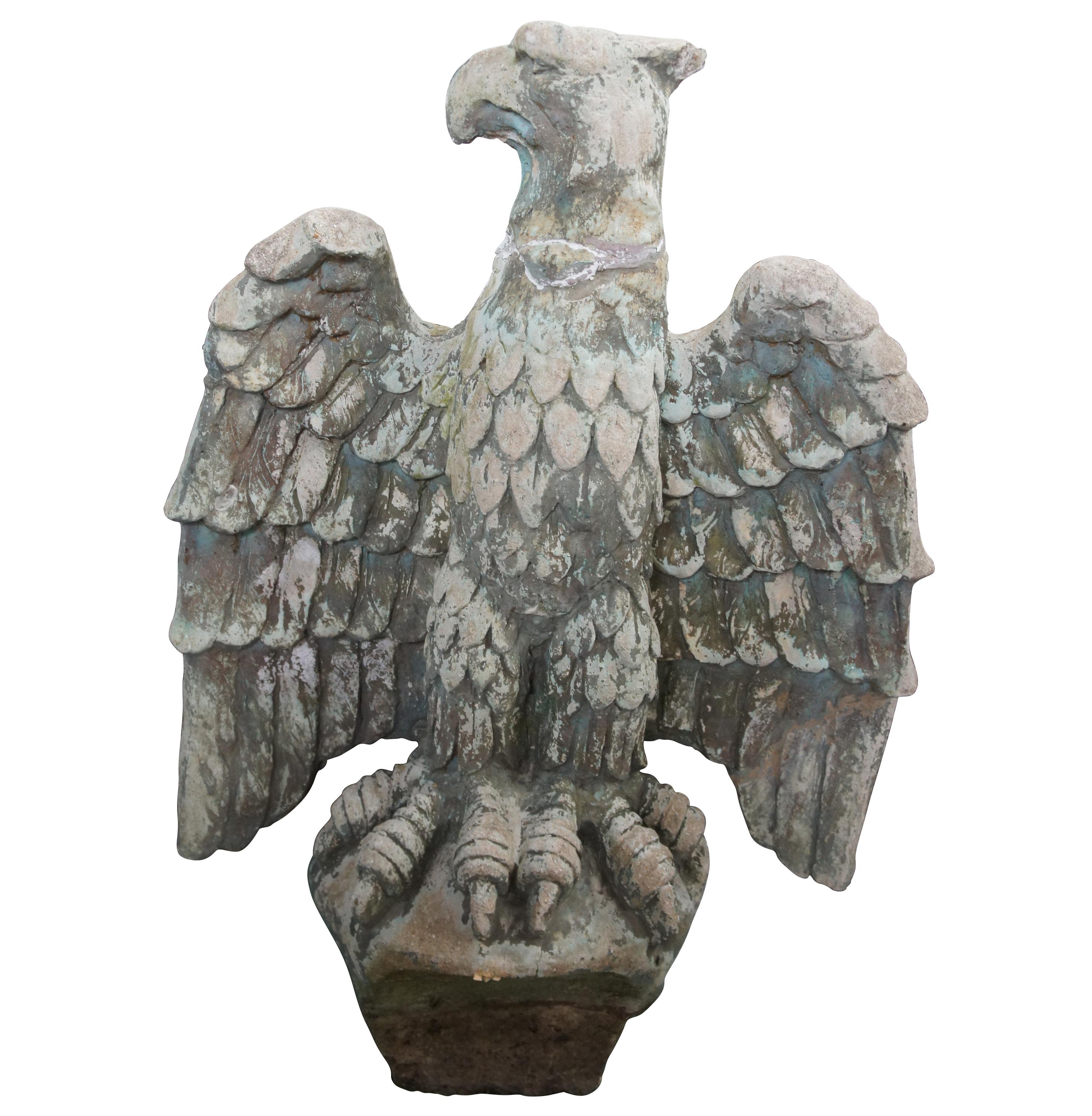 An impressive pair of early 20th century concrete / cast stone eagle sculptures. Lifelike in Size with apposing faces, outstretched wings and large talons. The bases of the statues are tapered allowing them to inset into the ground nicely. These