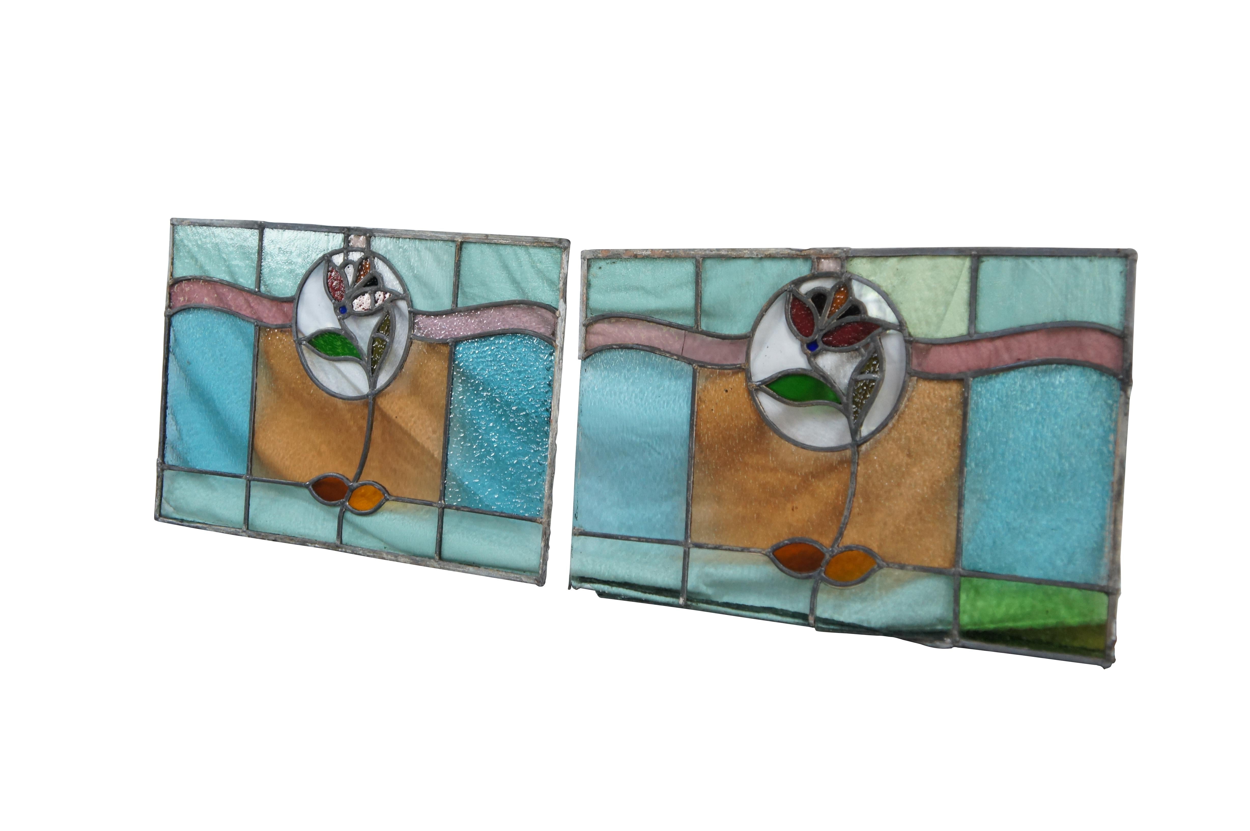 Beautiful antique leaded stained glass reclaimed window panels.  Features blues and ambers with a rose at the center. A fun set to hang in the light or reframe for use.   

Dimensions:
18