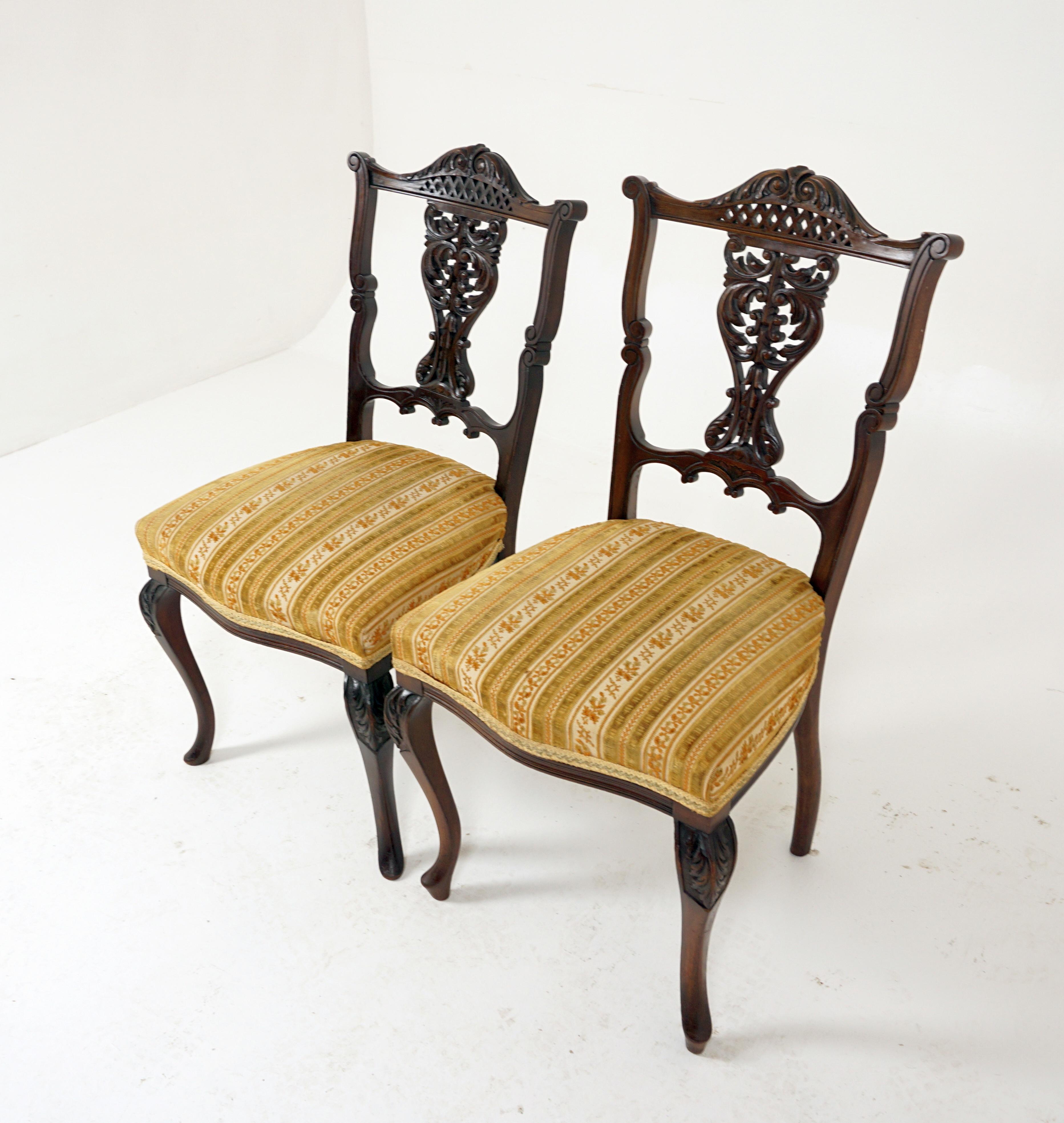 2 Antique Victorian walnut occasional chairs with fretwork 

Scotland 1910
Solid walnut
Original finish
Carved top rail with fret work vertical slat to the back
Upholstered seat with webbing underneath
All standing on a carved cabriolet legs