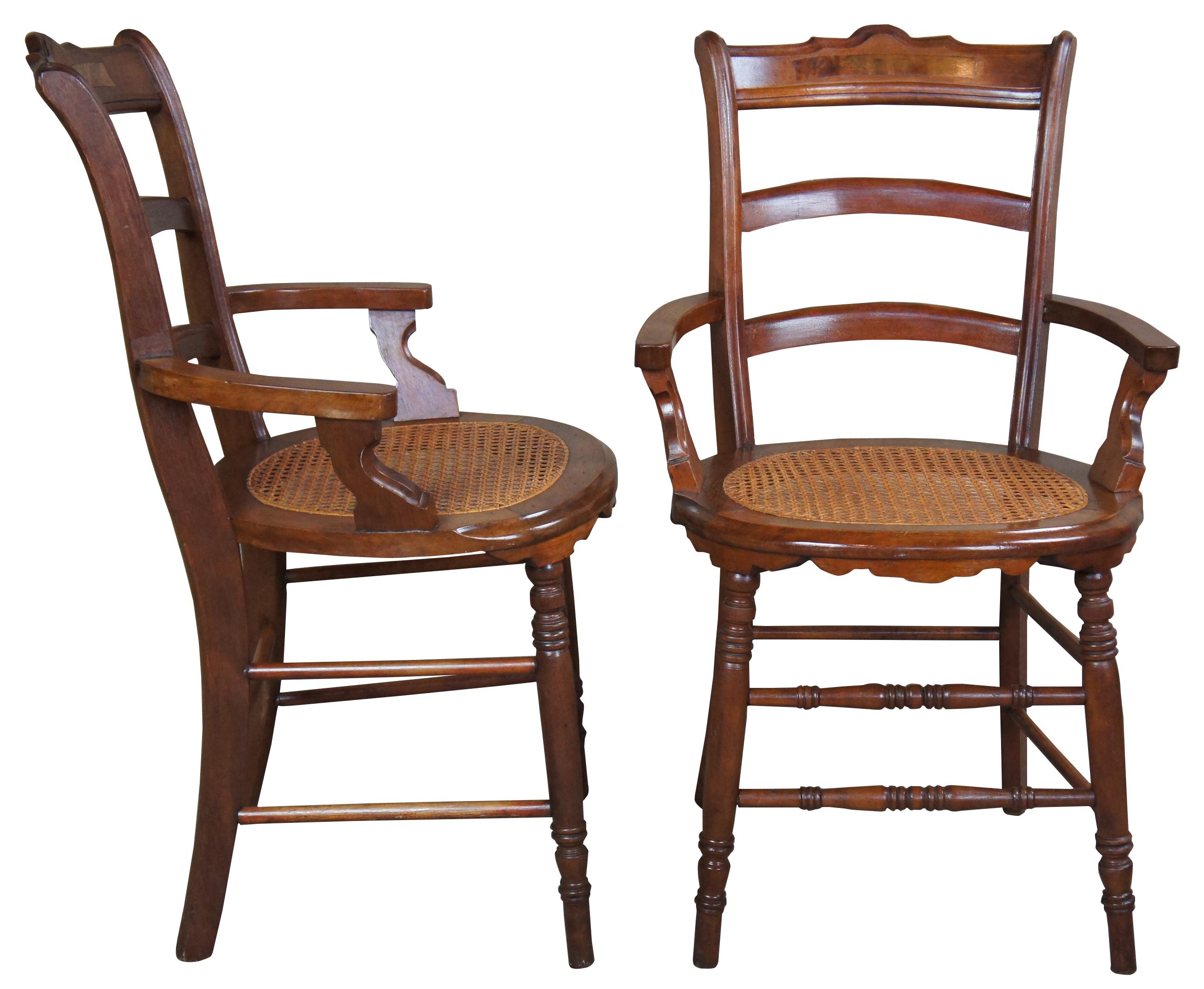 A neat pair of Victorian chairs, circa late 19th century. Made from walnut with burled panels, carved accents and a cane seat.