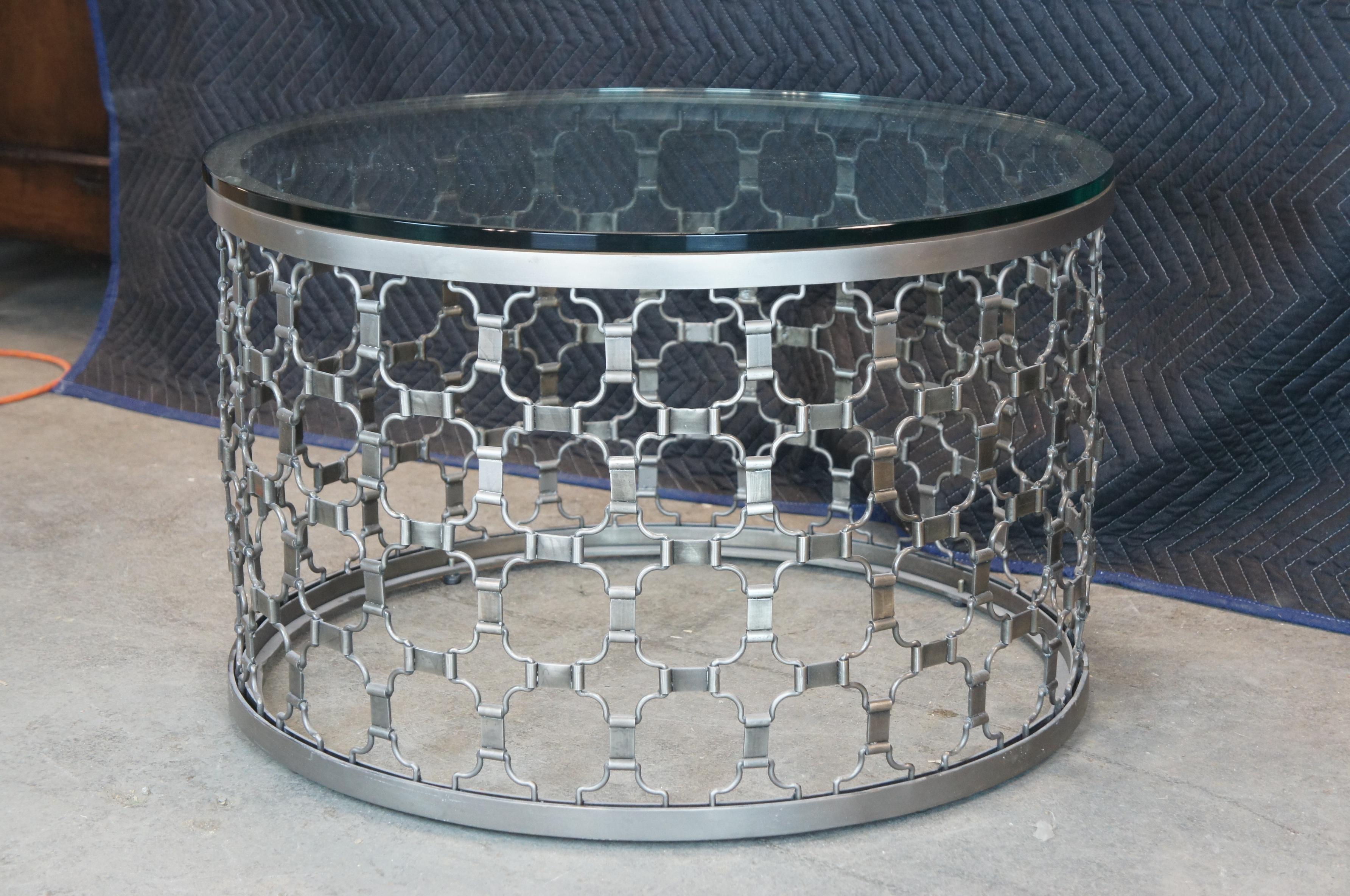 Arhaus Naomi coffe or accent table in Pewter finish. A nice mix of contemporaryy and modern styling. Made of aluminum featuring reticulated geometric design with glass top featuring polished edge. Retail $1799 each. Measures: 30''.
   