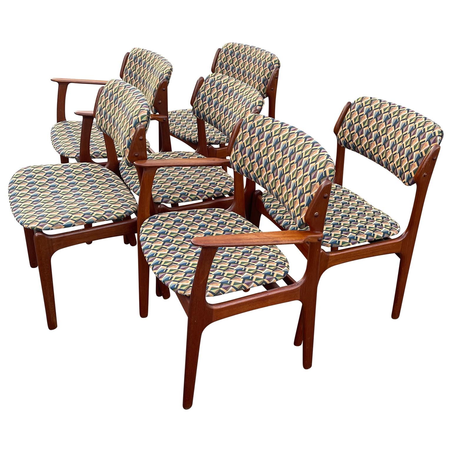 Set of six Danish Scandinavian Modern dining chairs, circa 1960. This beautiful set are designed by Erik Buch and made by Domus Odense Maskinsnedkeri represents classic Danish design. The teak wood is warm and glows in the light. The original fabric