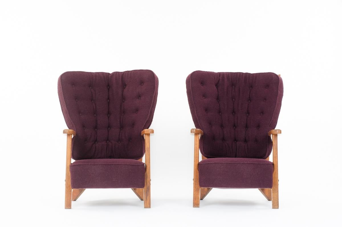 Famous set of 2 Guillerme and Chambron armchairs edited in 1950 by Votre maison. 
It's composed of a solid oak structure, and a seat and back in foam cover with a purple terry fabric.