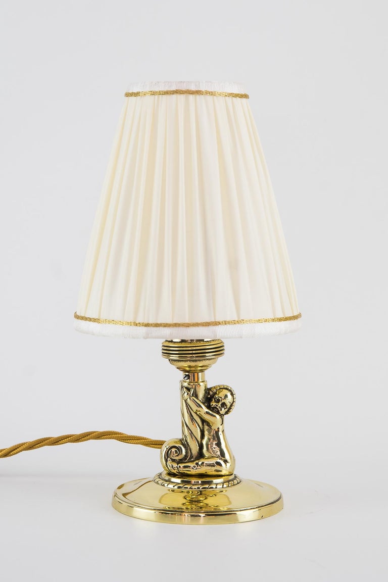2 Art Deco table lamps with shades, Vienna, circa 1920s
Brass polished and stove enameled
Shades are new (Replaced)
The costumer can choose between these two shade Modells
Measures: Height with the yellow shades: 27 cm
Height with the red
