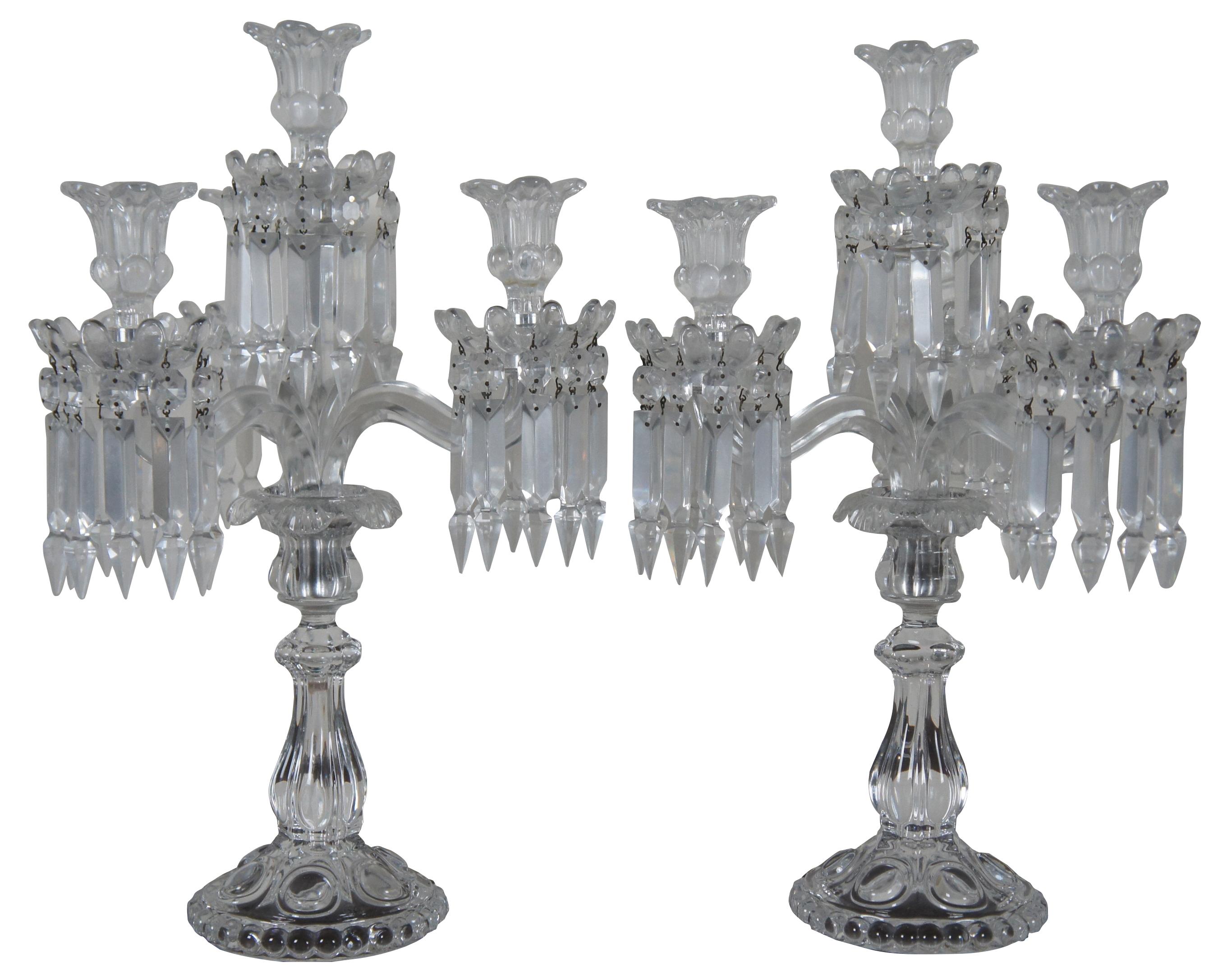 Pair of elegant Baccarat cut crystal candelabras with four flower shaped bobeches / candle holders surrounded by drop crystals / prisms. Marked on base. Made in France. Measure: 19