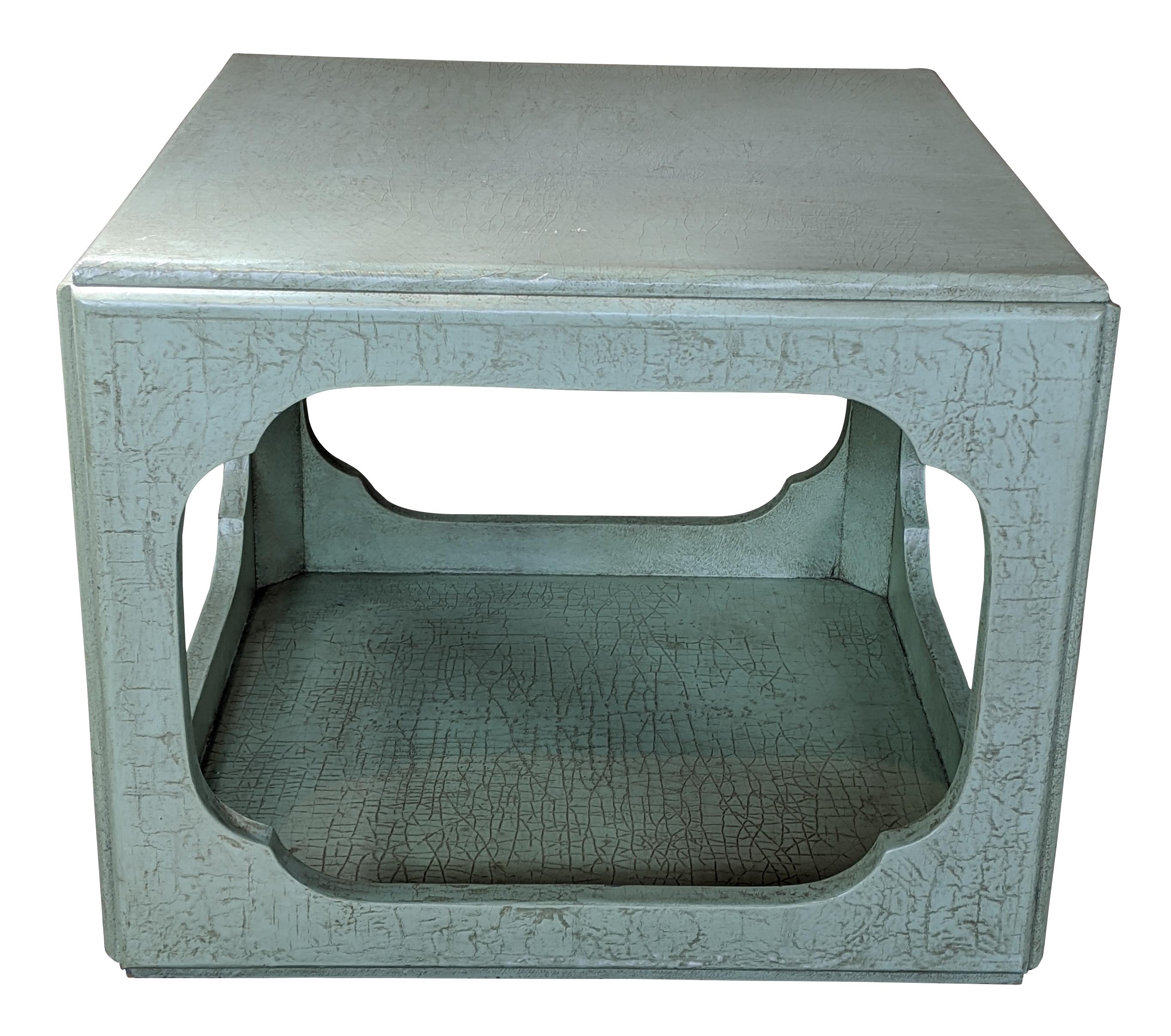 Most likely from Baker's Far East collection, these wonderful end tables have a traditional Asian form. Finished in celadon green craquelure lacquer, which is glazed with burnt umber to give it the appearance of crocodile leather, circa 1960s.