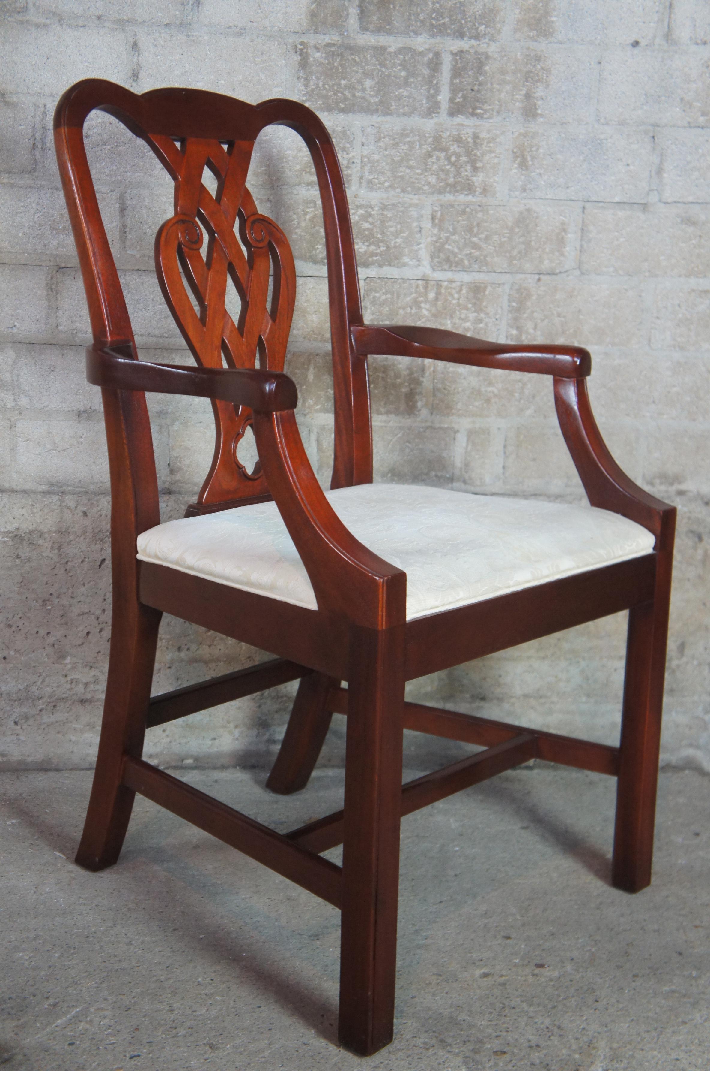 Baker dining chairs, circa 1980s. Made from mahogany with an interwoven pierced and carved back. Features a brocade upholstered white seat.
  