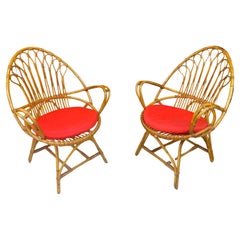 2 fauteuils en bambou et rotin et leurs coussins, datant d'environ 1970