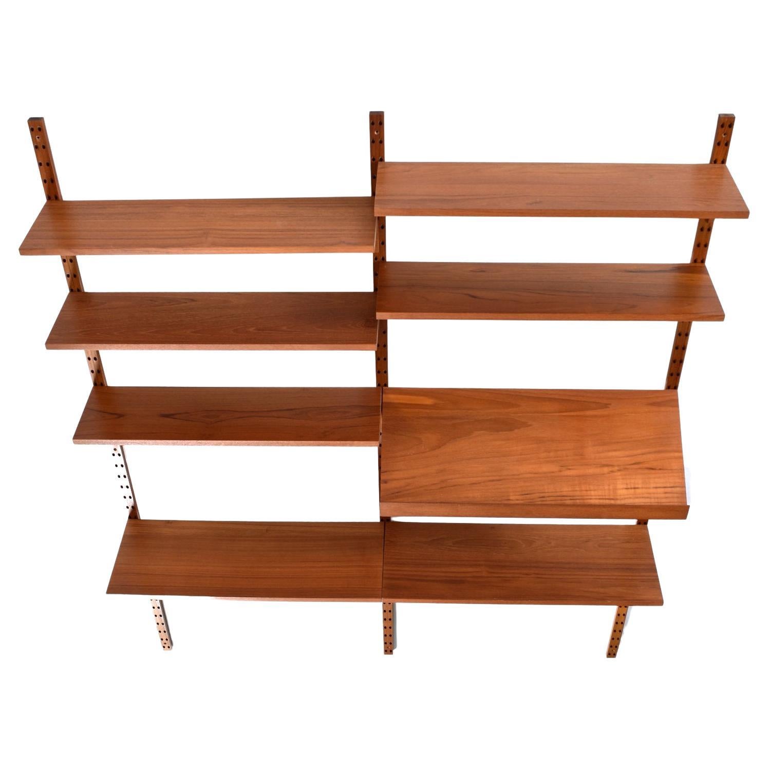 Two-bay Danish teak wall mounted shelving system designed by Poul Cadovius. Vintage 1960s, the CADO’s modular shelving system remains an everlasting icon. The ingenious design allows one to easily customize the height, position and amount of