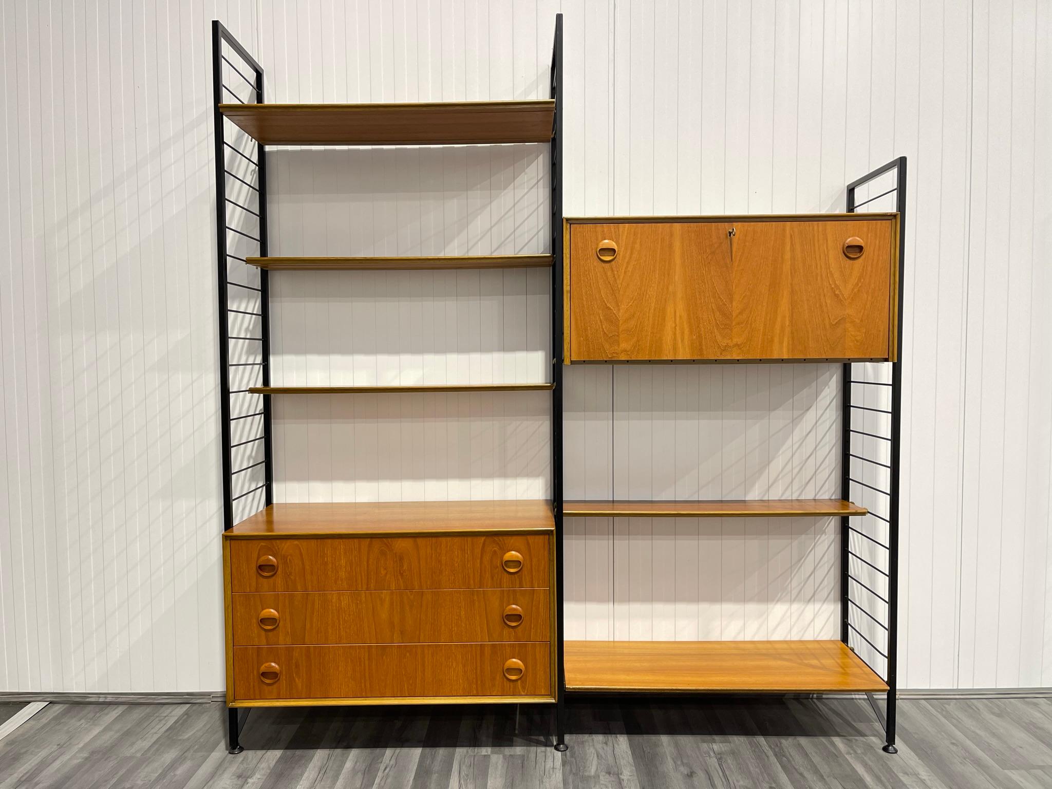 Stylish and functional, this is the classic Staples Ladderax mid century shelving system. The black metal uprights and easy removable supports, allow the cabinetry to be positioned wherever required. This is a very versatile piece of retro