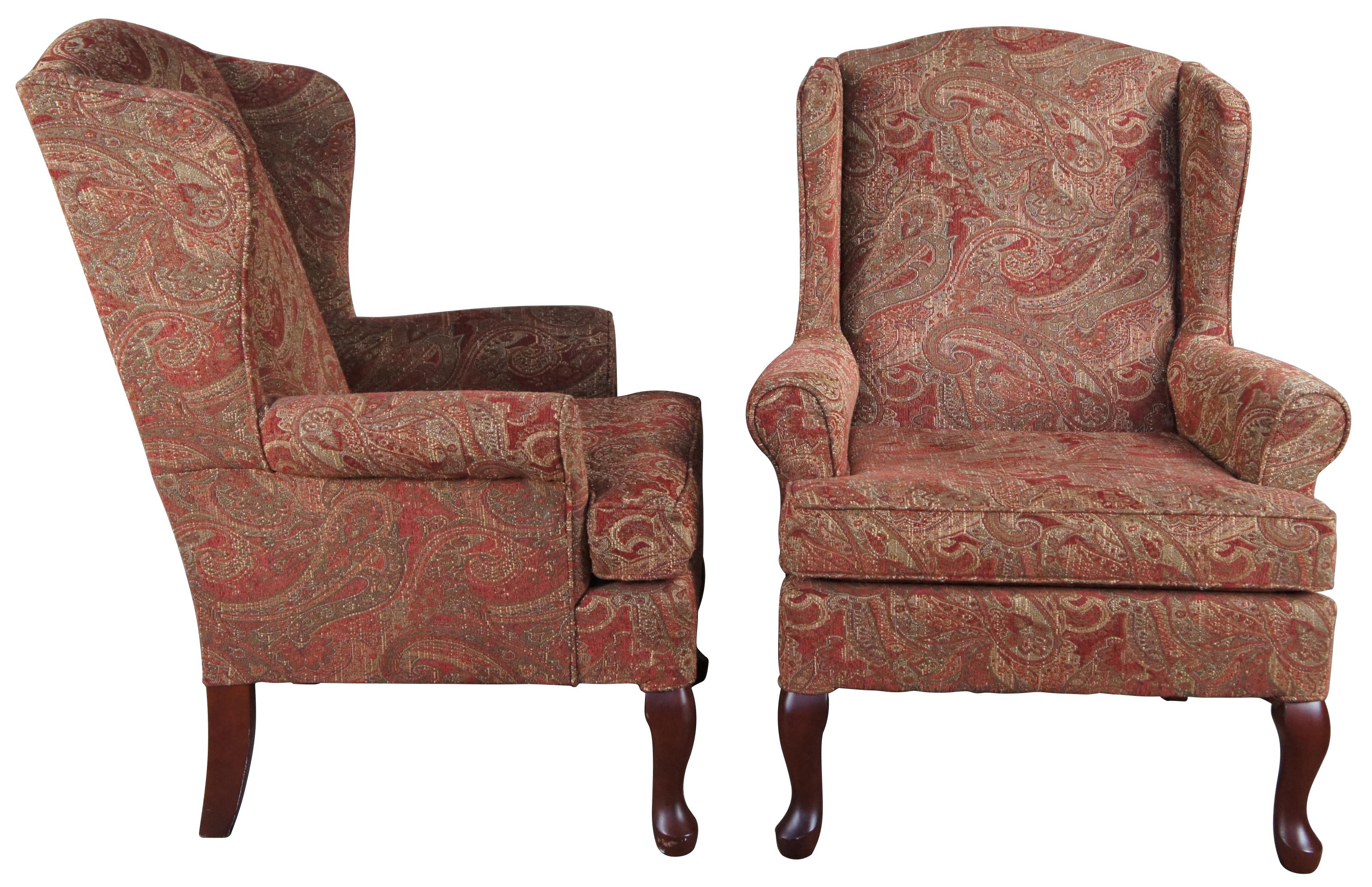 Pair of Best Home Furnishing Wing Chairs. Upholstered in a red and gold fabric with spice finished legs. 

In 1962, two men turned their chair expertise into a yet unknown empire. Over 60 years later, Best Chairs has surpassed all expectations